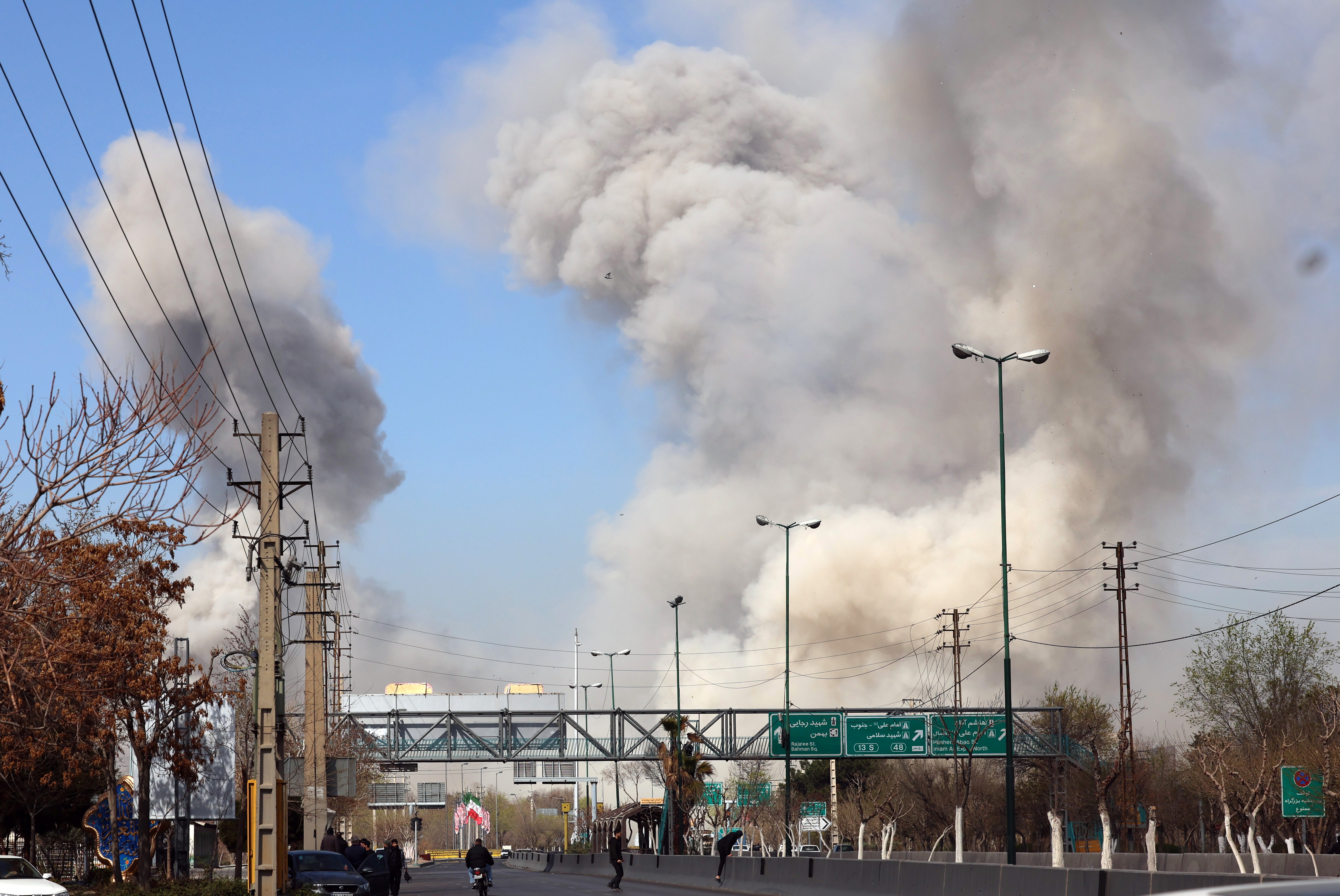 epaselect epa12796261 People run for safety as smoke rises after an airstrike in central Tehran, Iran, 05 March 2026. A joint Israeli and US military operation continues to target multiple locations across Iran since the early hours of 28 February 2026. EPA/ABEDIN TAHERKENAREH