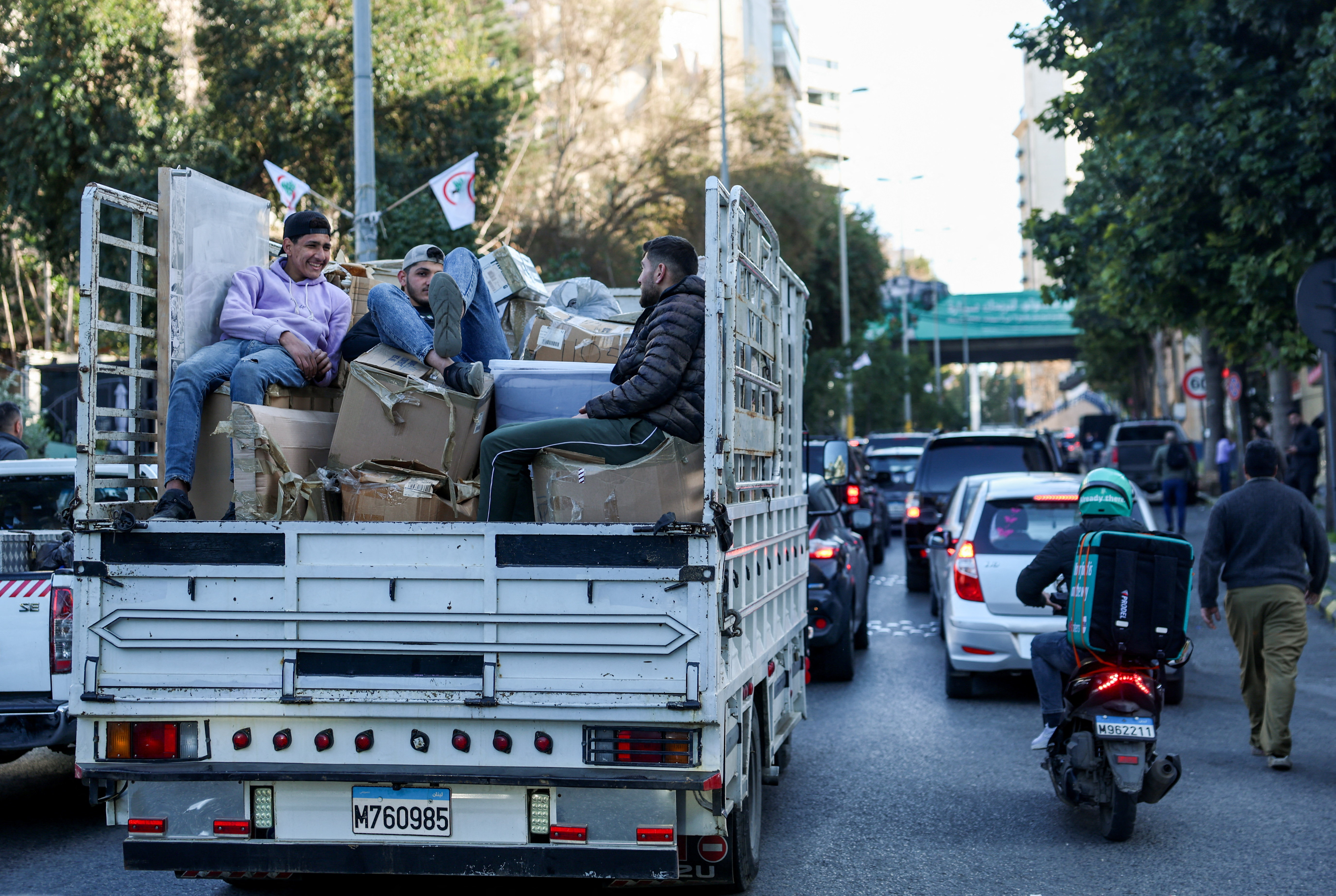 People sit on the back of a vehicle as they wait in traffic, after the Israel's military issued evacuation orders of entire neighborhoods in Beirut's southern suburb, following an escalation between Hezbollah and Israel amid the U.S.-Israeli conflict with Iran, in Beirut, Lebanon, March 5, 2026. REUTERS/Claudia Greco