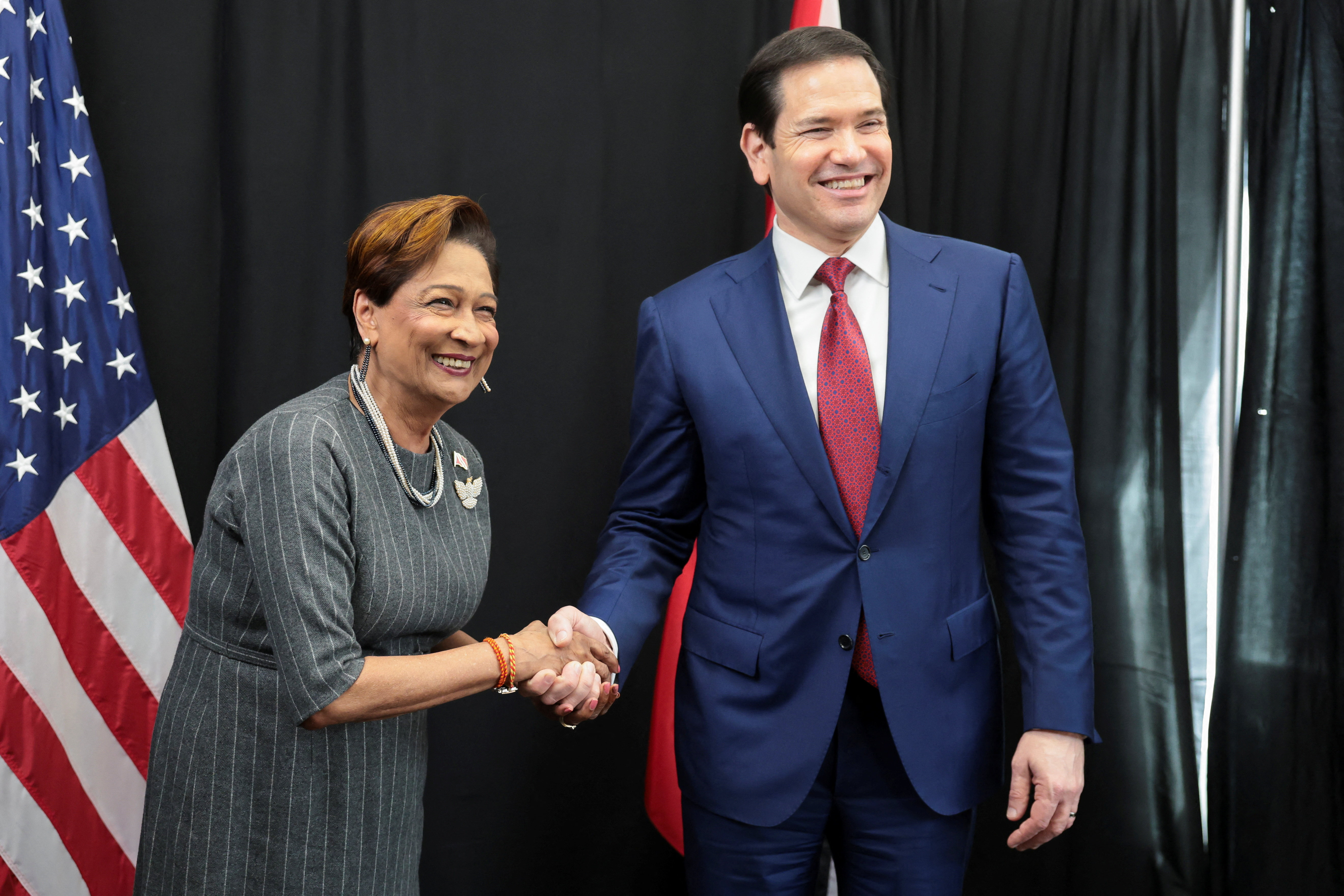 U.S. Secretary of State Marco Rubio shakes hands with Trinidad and Tobago Prime Minister Kamla Persad-Bissessar alongside Caribbean Community (CARICOM) meetings in Basseterre, Saint Kitts and Nevis, February 25, 2026. REUTERS/Jonathan Ernst/Pool