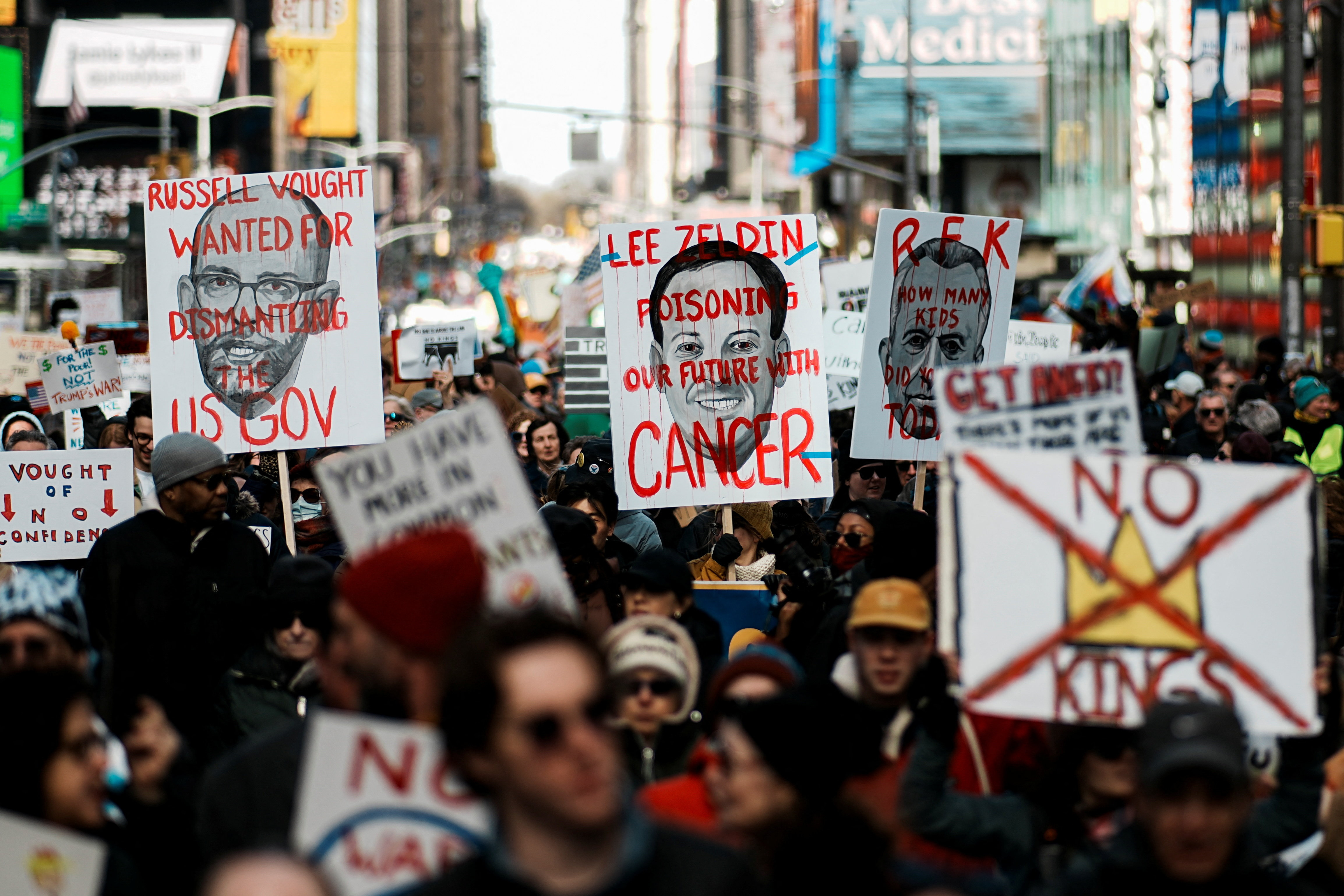 Demonstrators hold signs during a "No Kings" protest against U.S. President Donald Trump's administration policies, in New York City, New York, U.S., March 28, 2026. REUTERS/Eduardo Munoz
