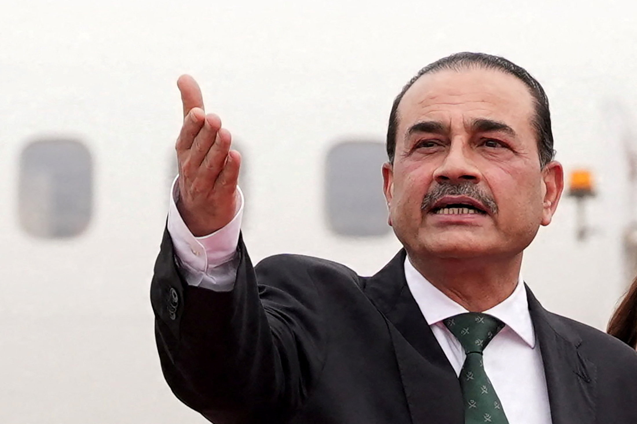 Pakistan's Army Chief, Field Marshal Asim Munir gestures as he walks with U.S. Vice President Vance (unseen) upon his arrival for peace talks with Iranian officials in Islamabad, Pakistan, April 11, 2026. Jacquelyn Martin/Pool via REUTERS