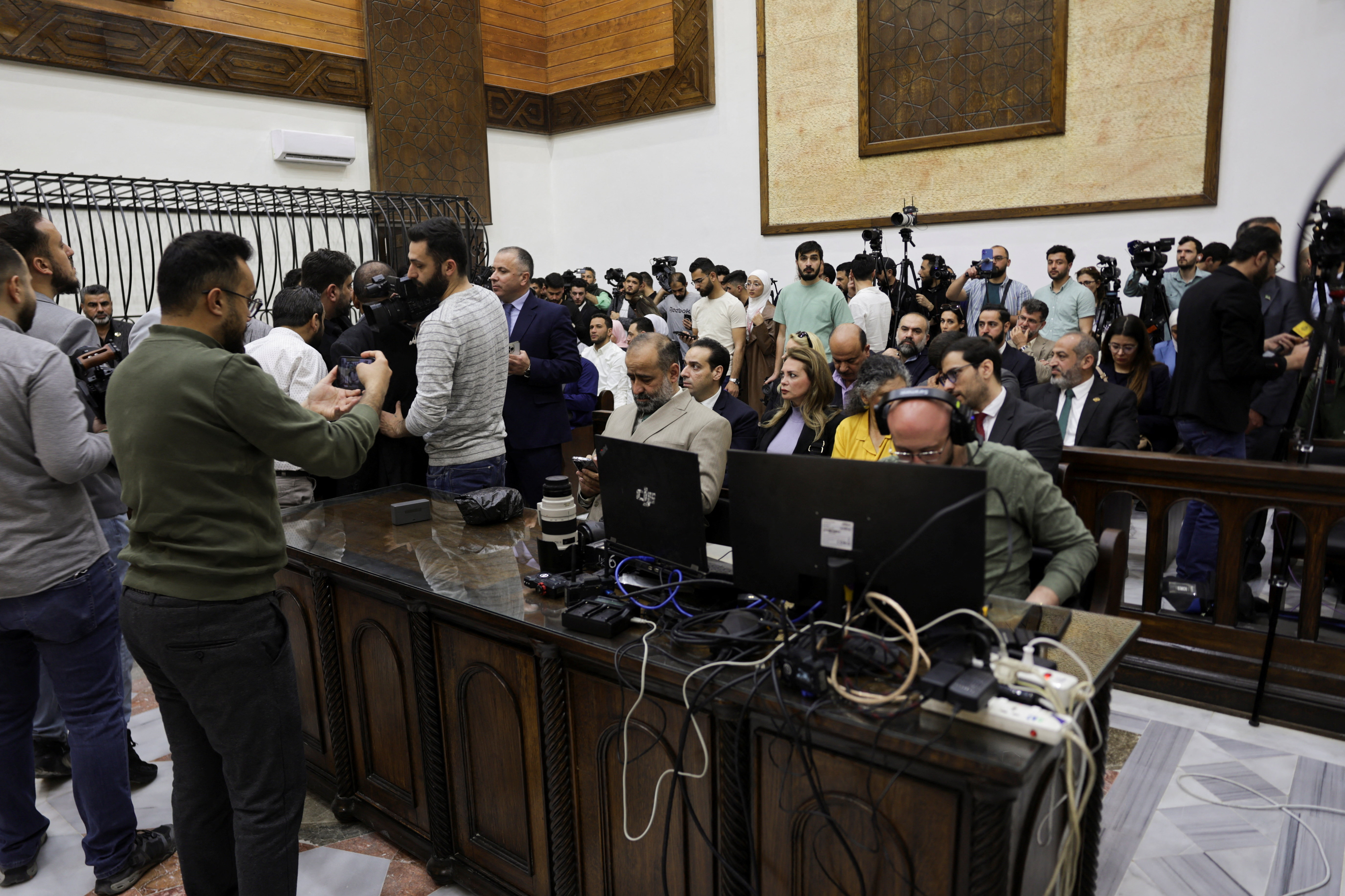 People gather in the courtroom, on the day Atef Najib, a brigadier general and former head of the Political Security Department in Daraa during Syria's ousted President Bashar al-Assad's rule, who is accused of committing war crimes, attends a trial session at the Palace of Justice, in Damascus, Syria, April 26, 2026. REUTERS/Khalil Ashawi