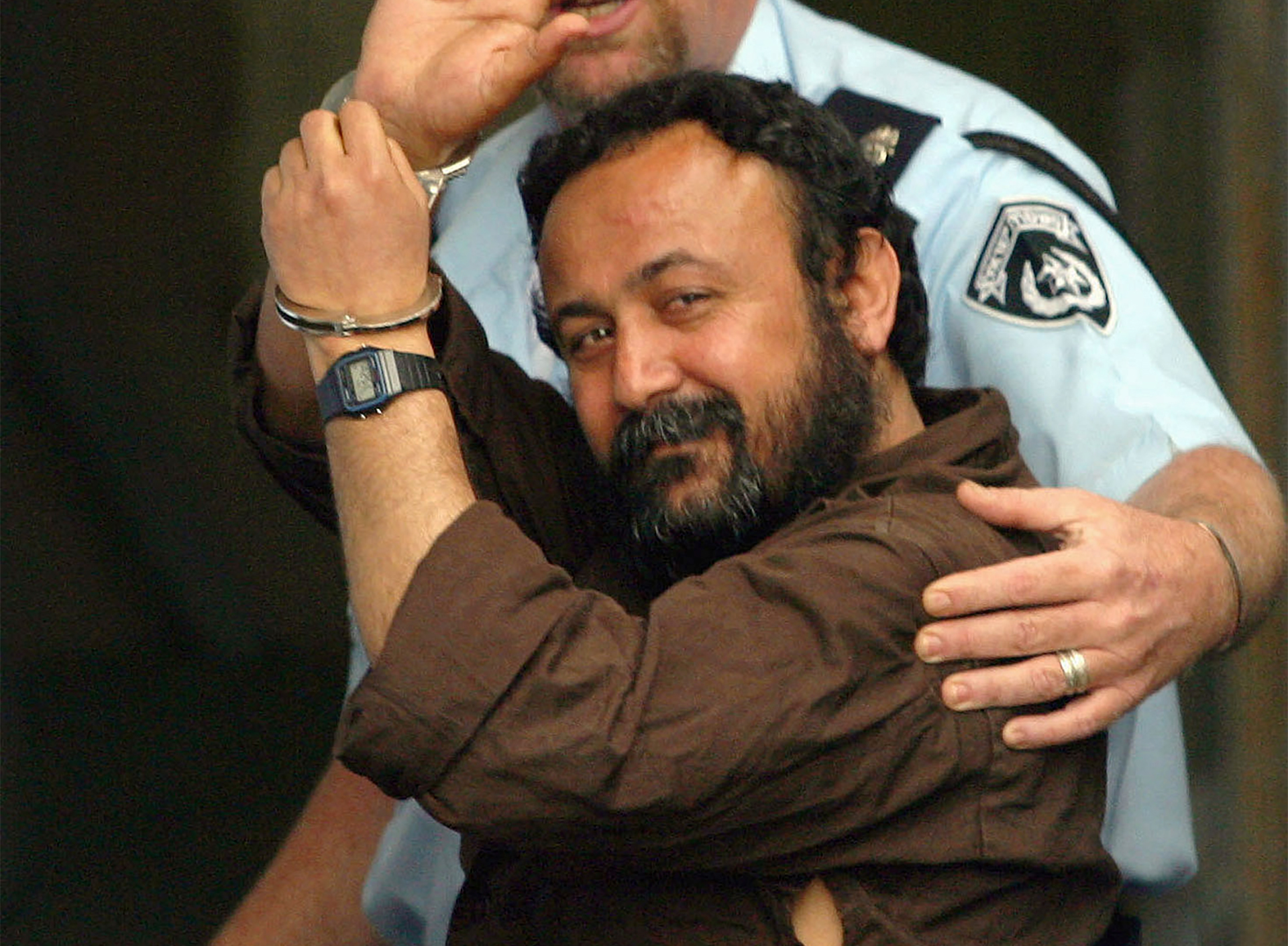 In this April 6, 2003 file photo, Marwan Barghouti waves as he enters a Tel Aviv court. [Jeremy Feldman/AP Photo]