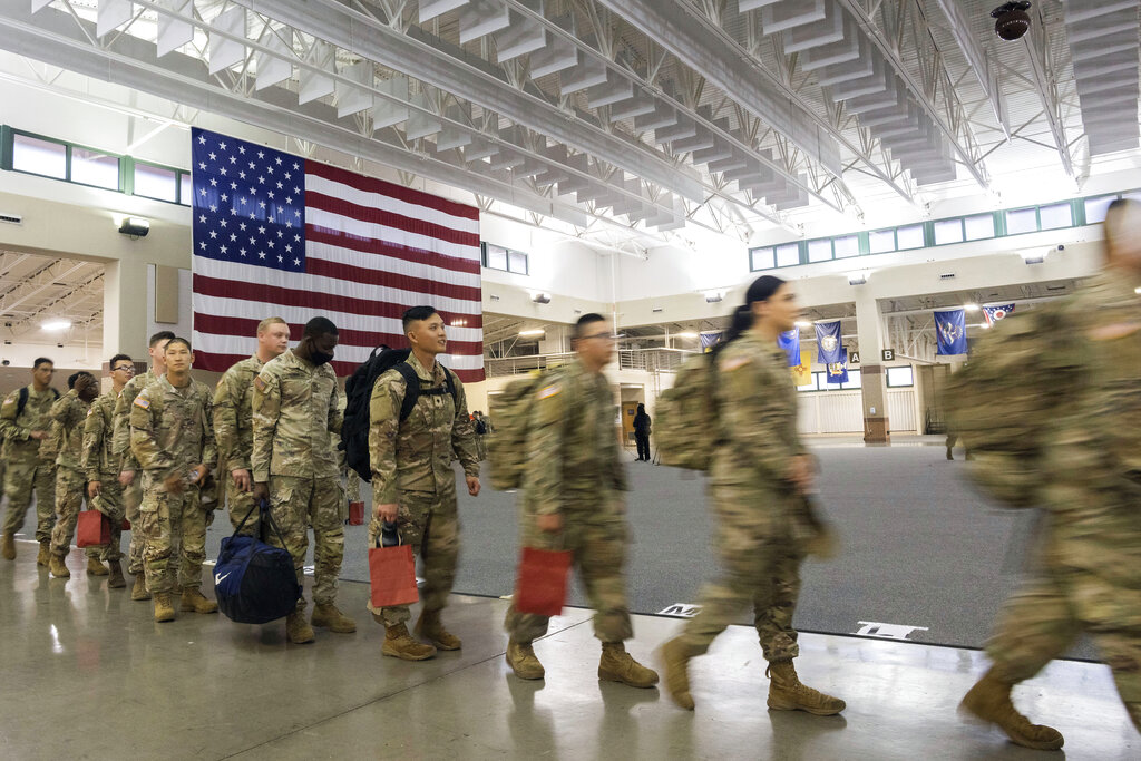 About 130 soldiers with the US Army’s 87th Division Sustainment Support Battalion, 3rd Division Sustainment Brigade, wait to board a chartered plane during their deployment to Europe, March 11, 2022, at Hunter Army Airfield in Savannah, Georgia, US