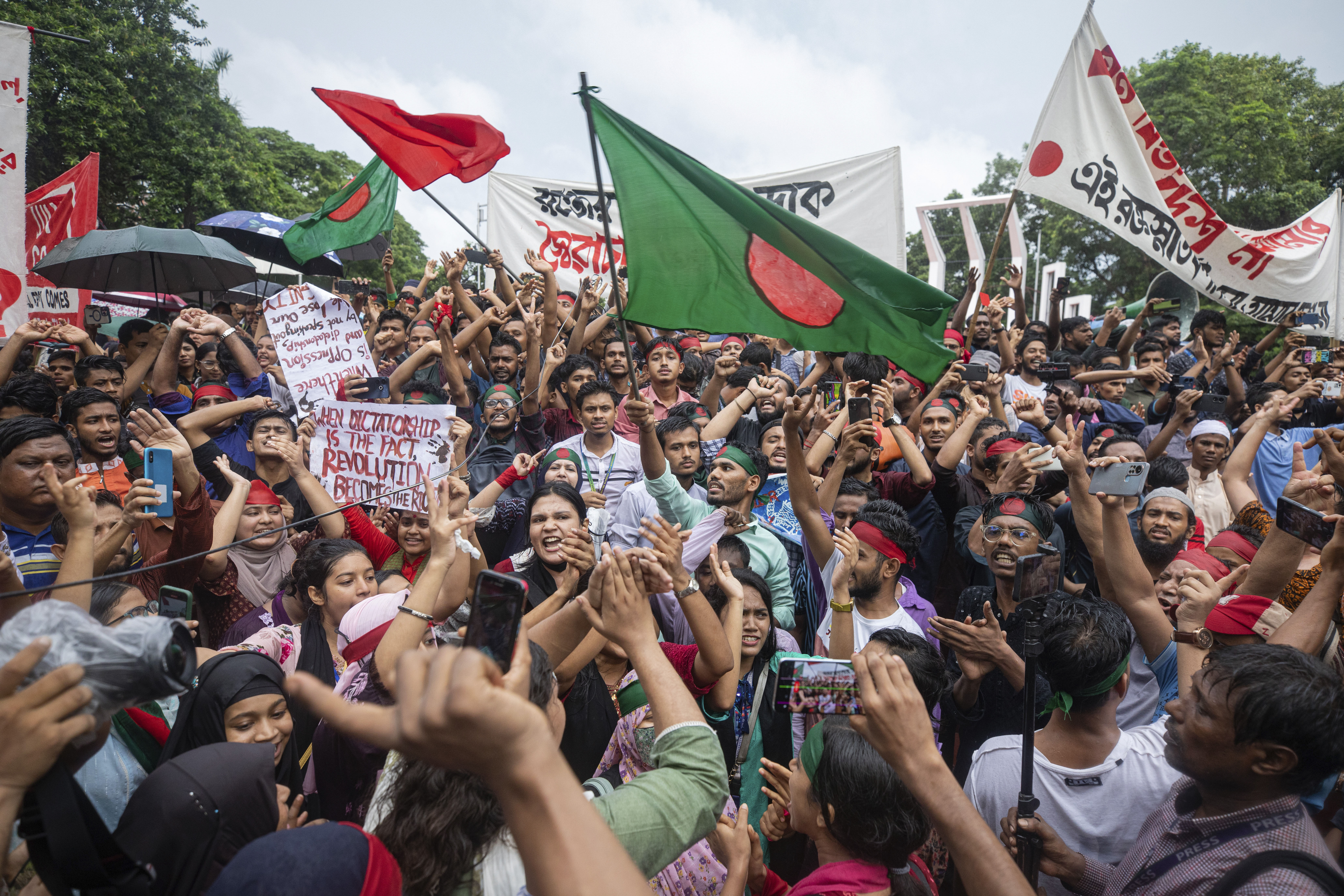 Activists take part in a protest march against Prime Minister Sheikh Hasina and her government in Dhaka