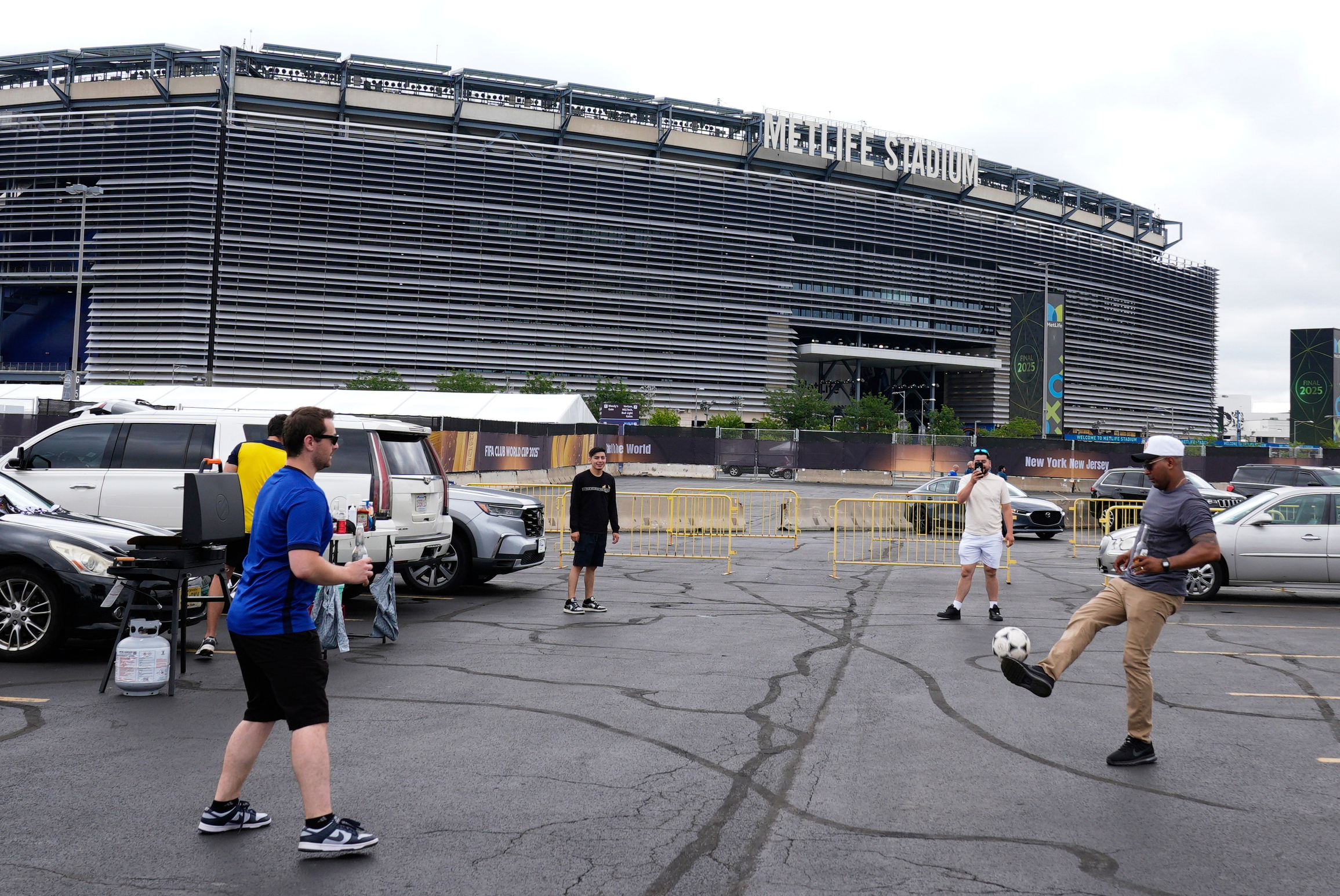 Football fans play outside World Cup stadium.