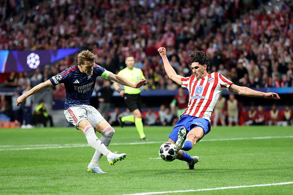 Martin Odegaard of Arsenal has a shot blocked by Johnny Cardoso of Atletico de Madrid