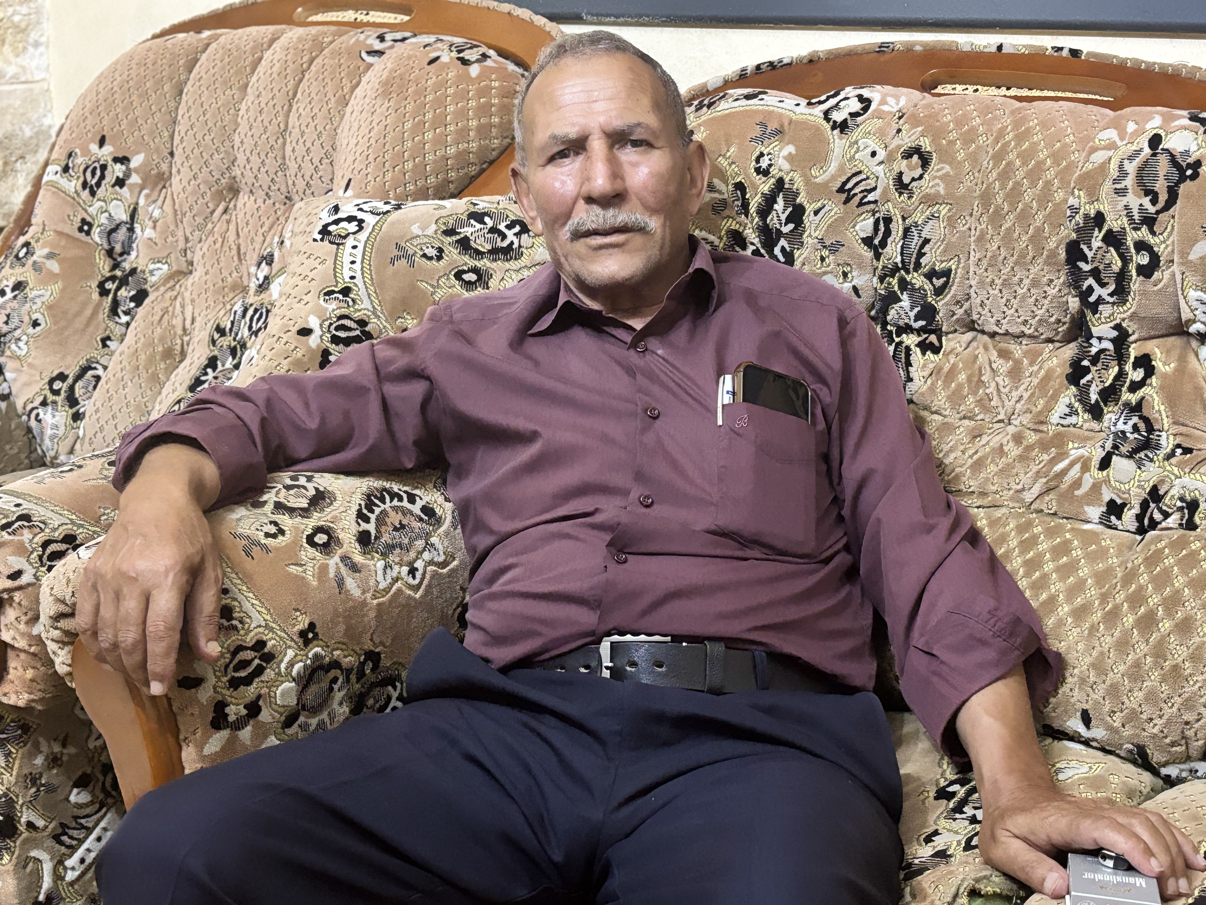 Hani Odeh sits in an armchair