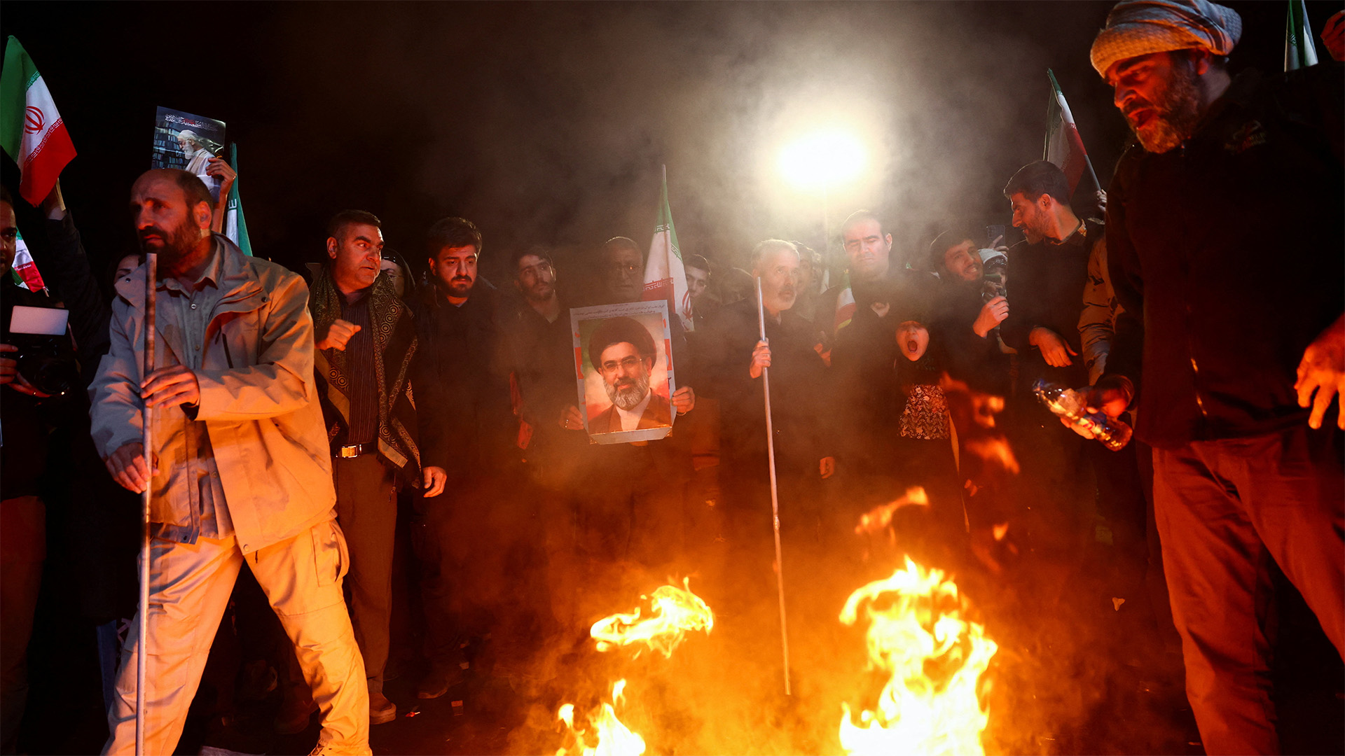 A man holds a photo of Iran's Supreme Leader, Mojtaba Khamenei, as people gather after a two-week ceasefire in the Iran war was announced, in Tehran, Iran, April 8, 2026.