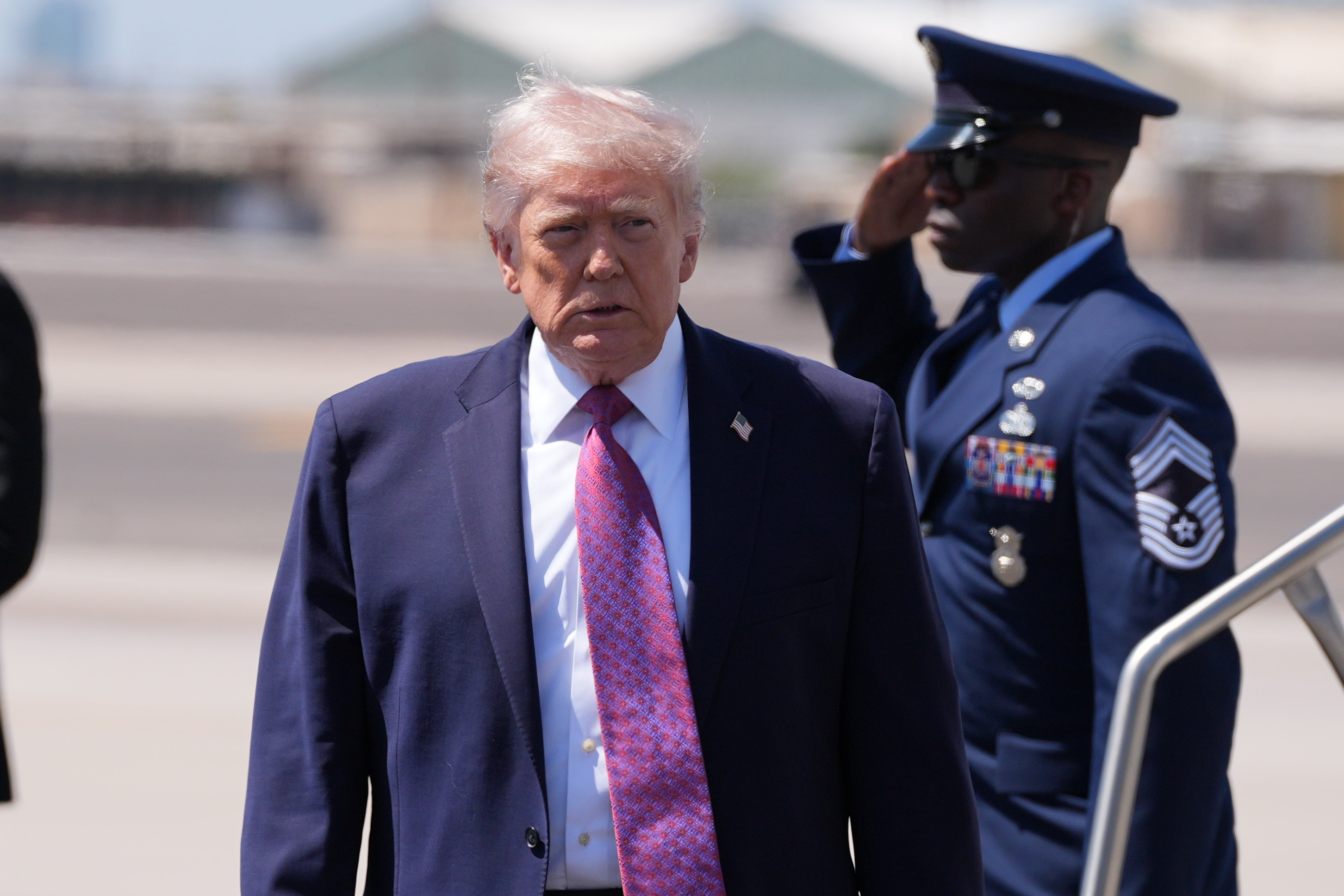President Donald Trump walks to talk with reporters after arriving on Air Force One, Friday, April 17, 2026, at Phoenix Sky Harbor International Airport in Phoenix. (AP Photo/Alex Brandon)