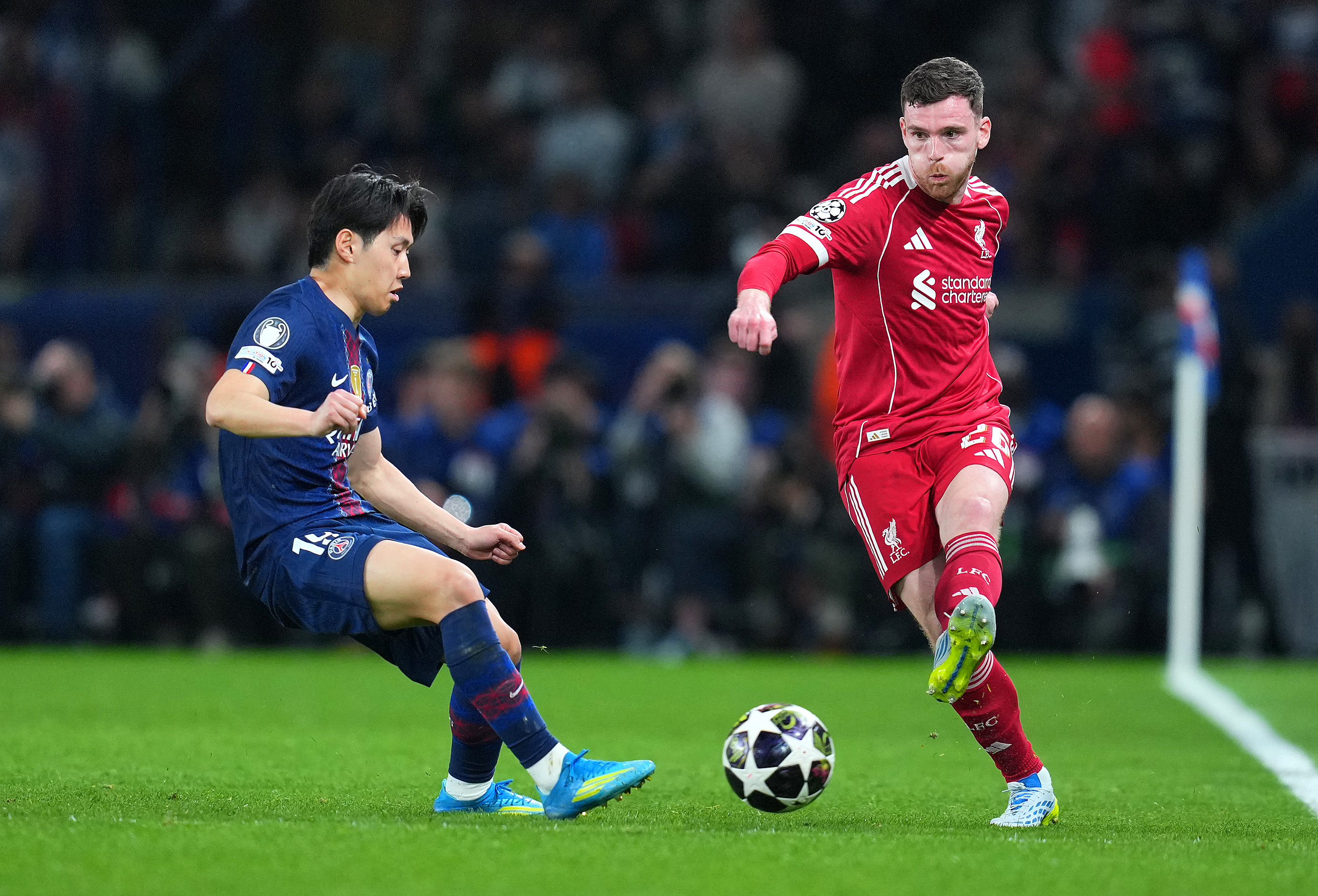 PARIS, FRANCE - APRIL 08: Andrew Robertson of Liverpool passes the ball while under pressure from Lee Kang-In of Paris Saint-Germain during the UEFA Champions League 2025/26 Quarter-Final First Leg match between Paris Saint-Germain FC and Liverpool FC at Parc des Princes on April 08, 2026 in Paris, France. (Photo by Franco Arland/Getty Images)