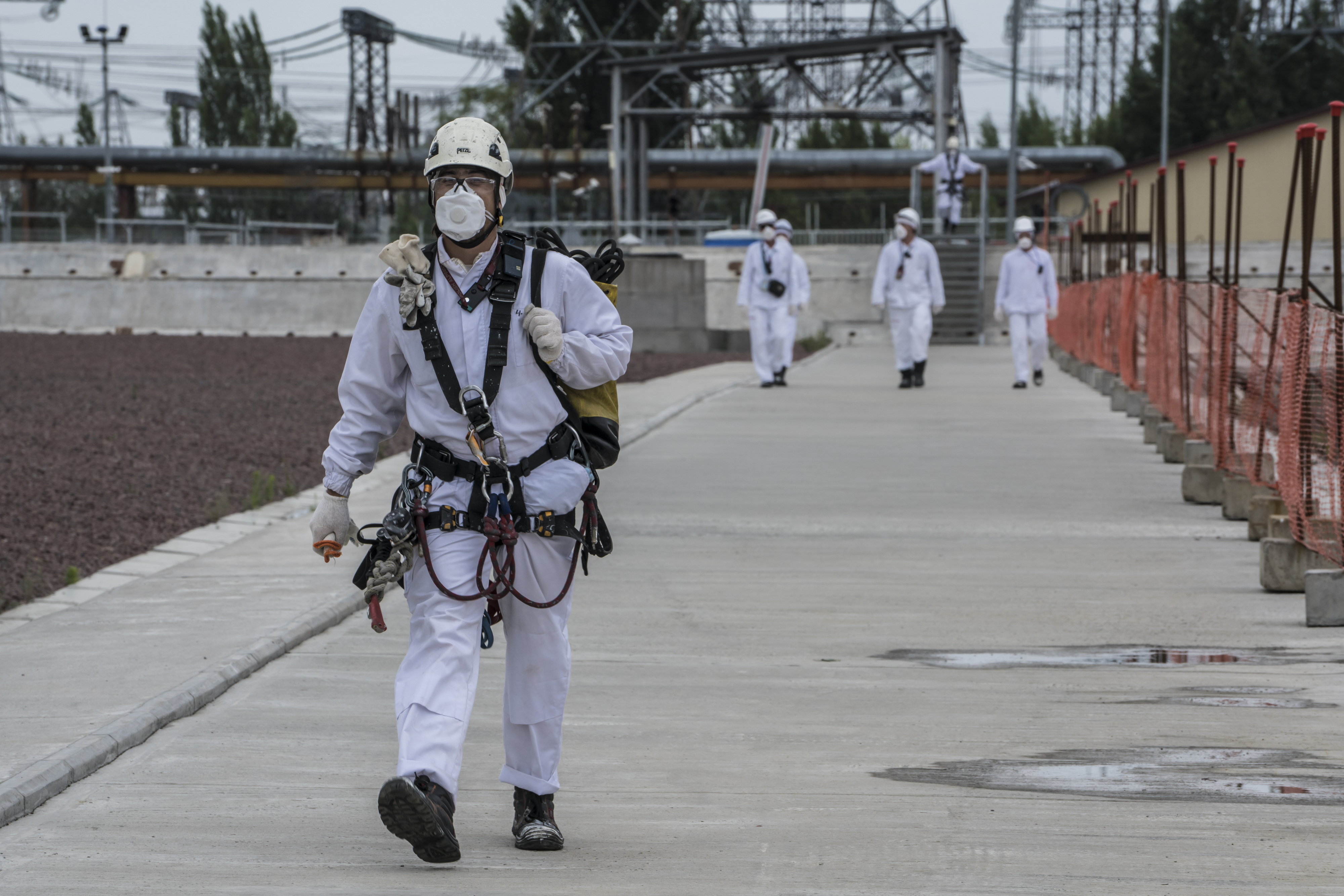 PRIPYAT, UKRAINE - JULY 2: Workers at the Chernobyl Nuclear Power Plant on July 2, 2019 in Pripyat, Ukraine. In November 2016, the 'New Safe Confinement' structure was shifted into place to prevent the decaying reactor from further contaminating the environment and eventually allow its dismantling; the Ukrainian government will soon be taking control of the new confinement structure. The power station's reactor number four exploded in April 1986, showering radiation over the local area, nearby regions of Belarus, and other portions of Europe. (Photo by Brendan Hoffman/Getty Images)