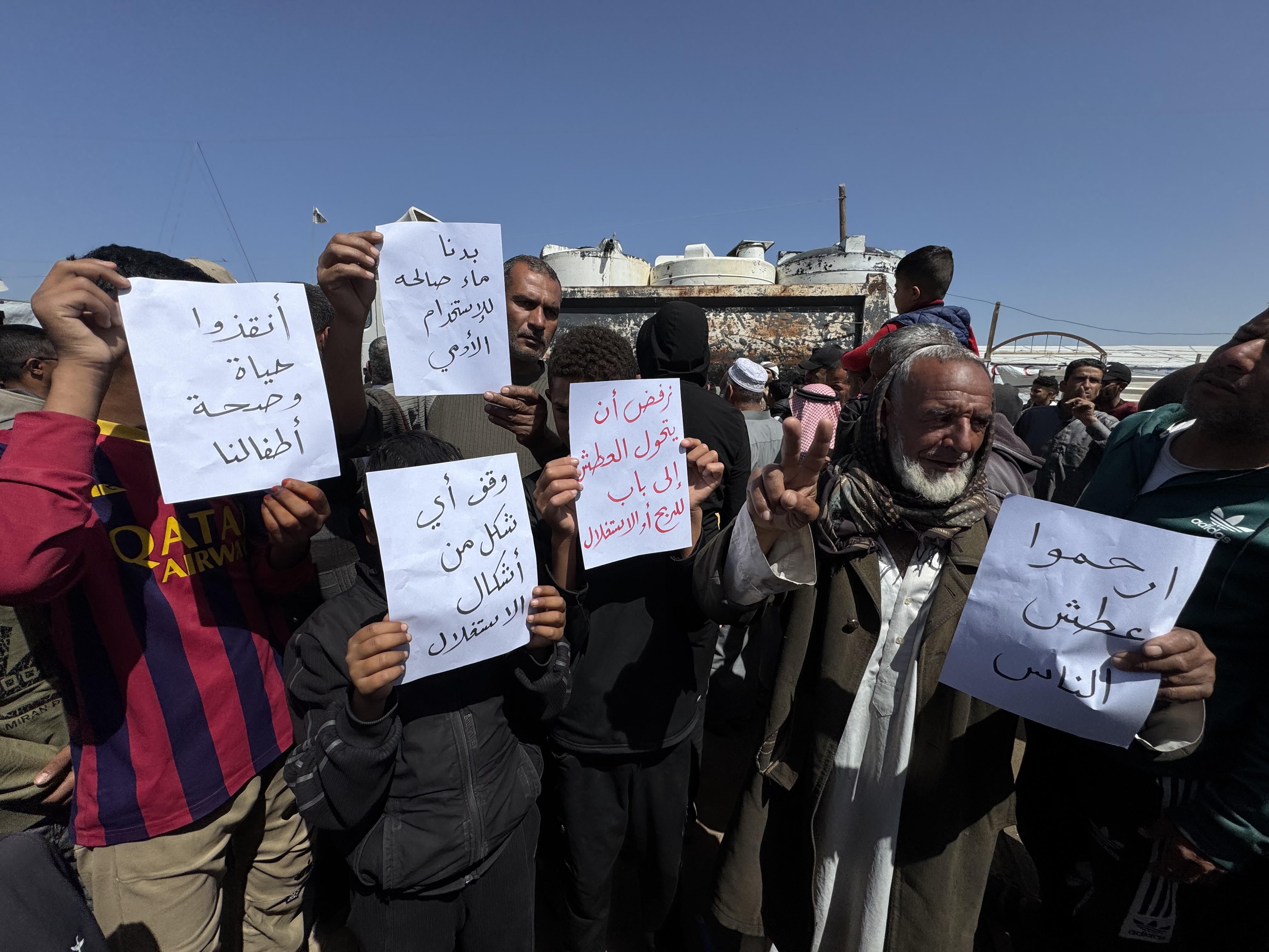 Protesters carry paper with slogans