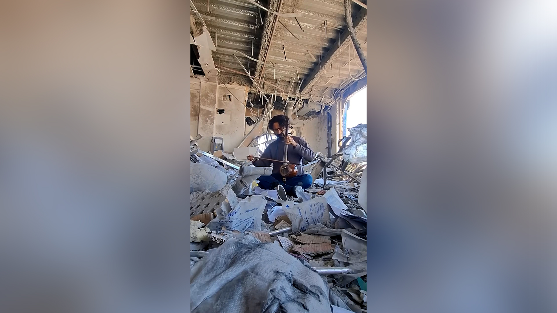 iranian_musician_plays_instrument_ruins_destroyed_building_us-israeli_strikes-1777041896