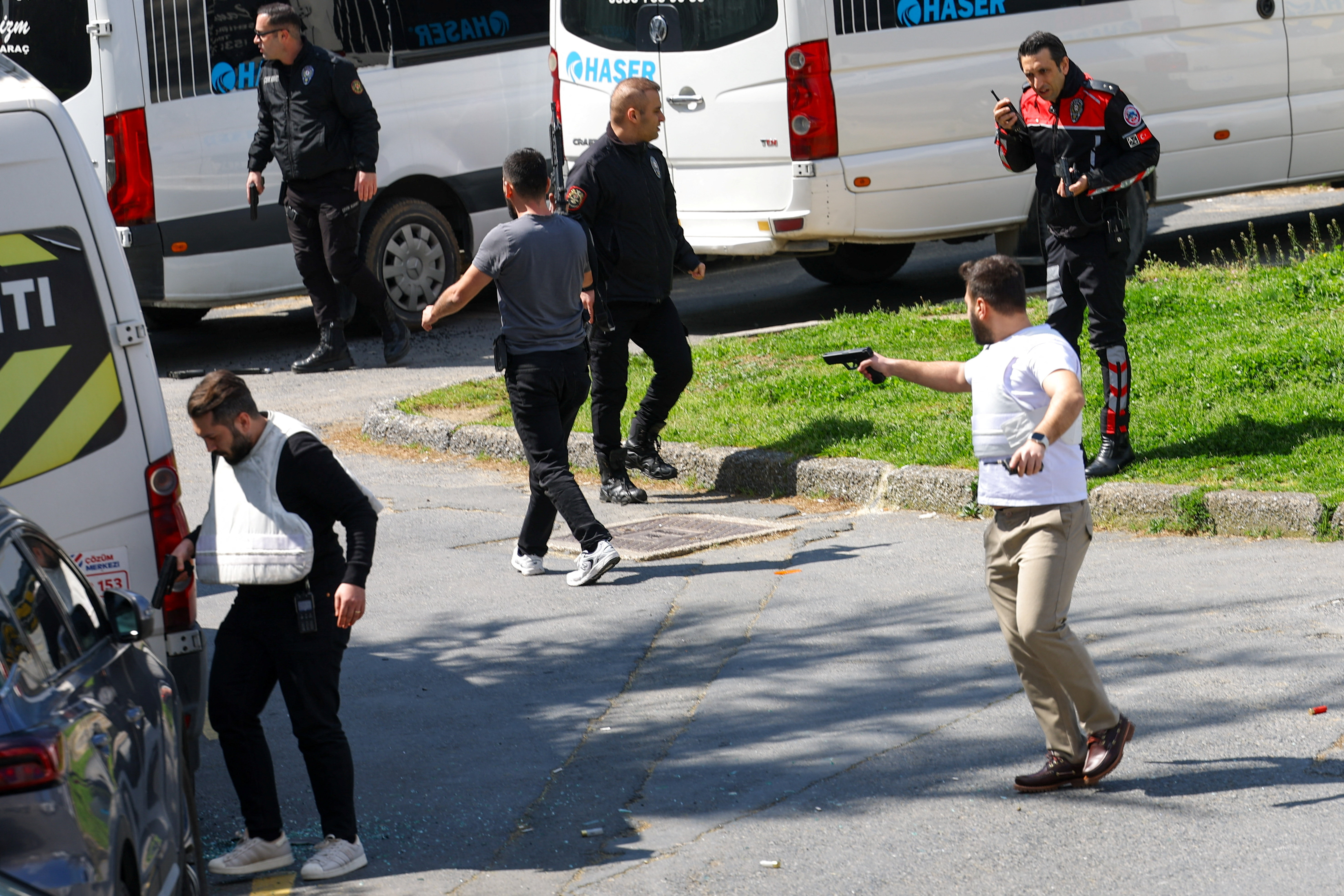 A man holds a gun, after gunfire was heard near the building housing the Israeli consulate, according to a witness, in Istanbul, Turkey, April 7, 2026. REUTERS/Murad Sezer
