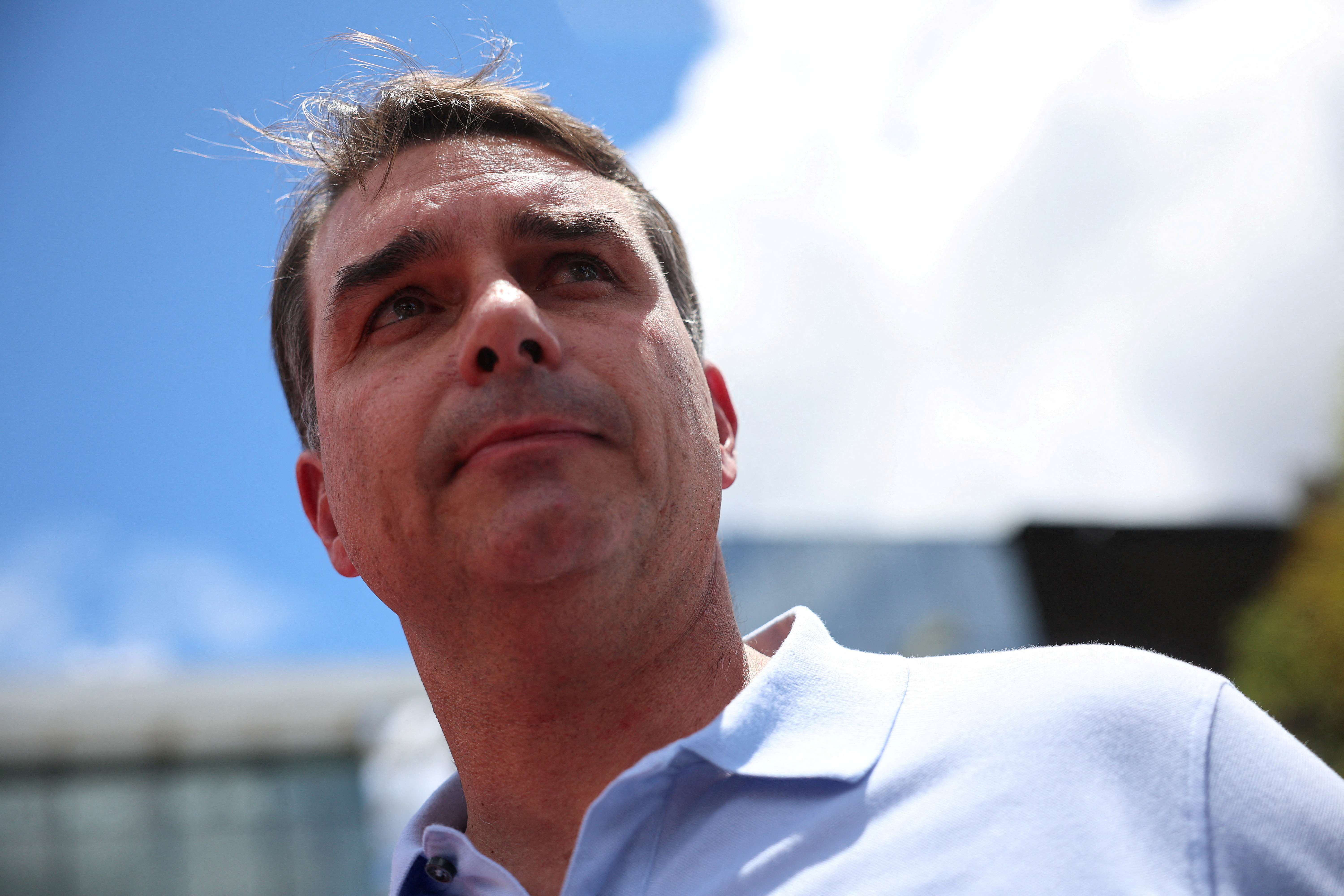 FILE PHOTO: Senator Flavio Bolsonaro attends a press conference outside a hospital, as his father, Brazil's former President Jair Bolsonaro is hospitalized, while serving a 27-year sentence for plotting a coup against his successor, President Luiz Inacio Lula da Silva, in Brasilia, Brazil, March 13, 2026. REUTERS/Adriano Machado/File Photo