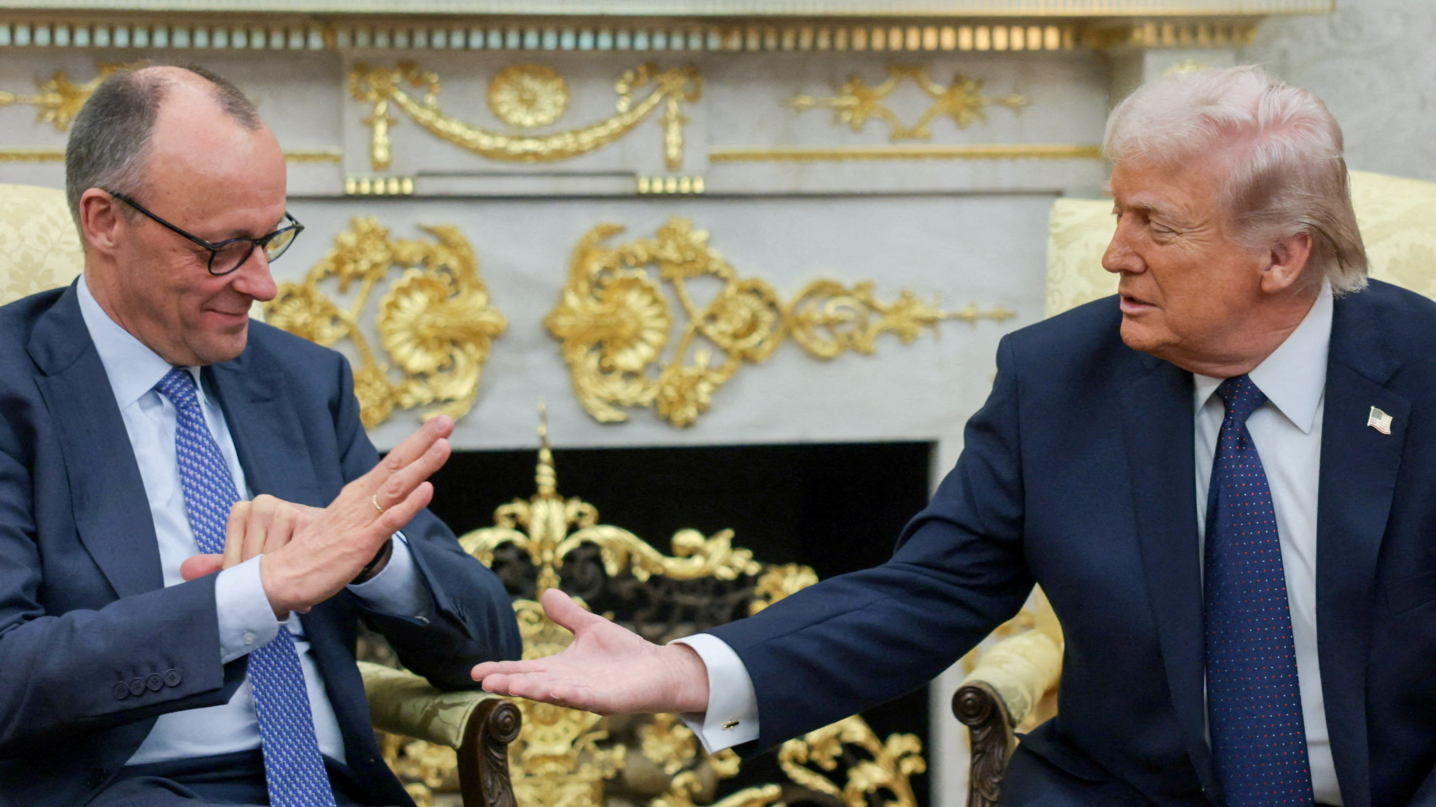 FILE PHOTO: U.S. President Donald Trump and German Chancellor Friedrich Merz reach to shake hands as they meet in the Oval Office at the White House in Washington, D.C., U.S., March 3, 2026. REUTERS/Jonathan Ernst/File Photo