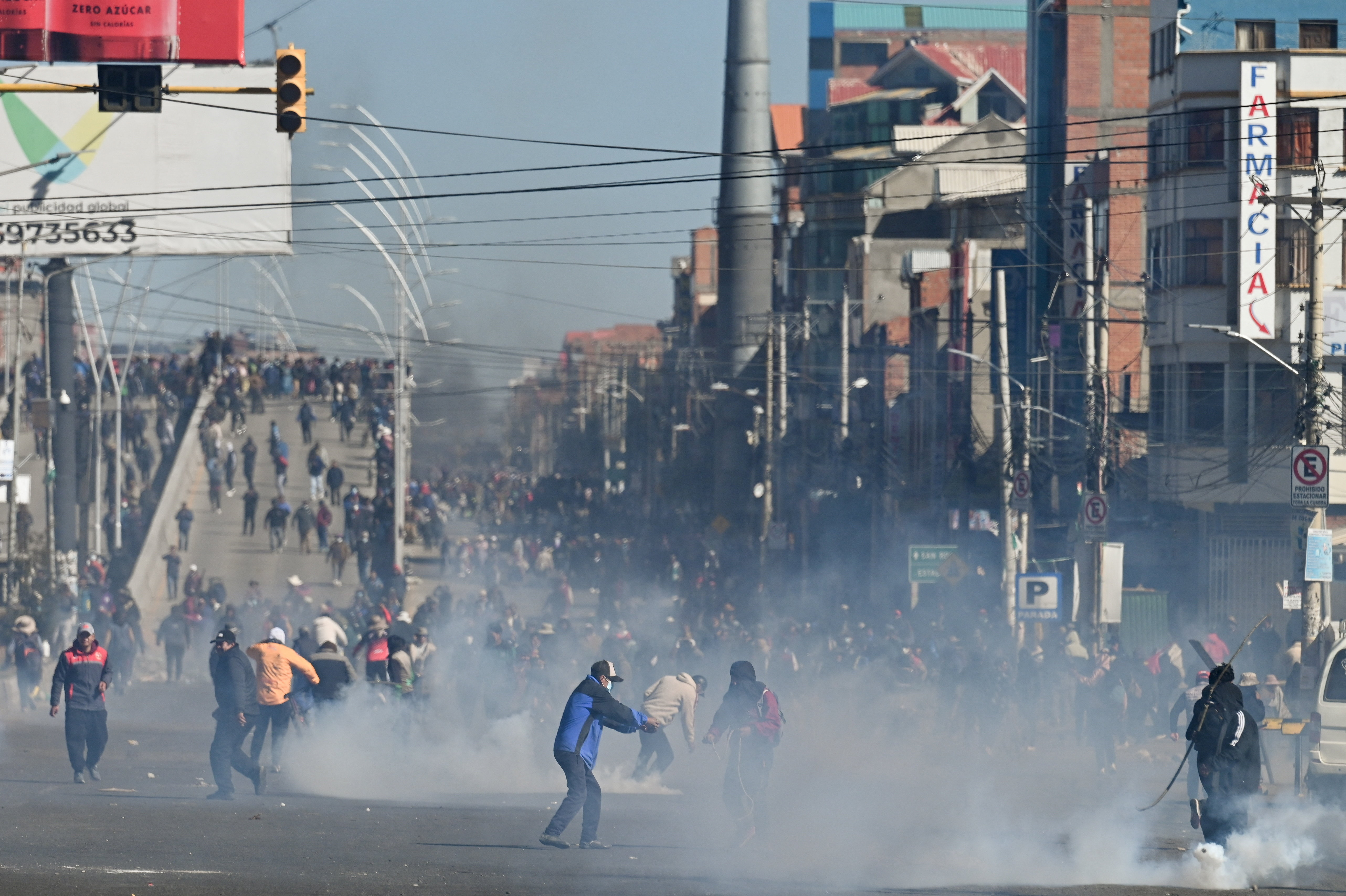 Demonstrators stand amid tear gas as they protest against President Rodrigo Paz's government amid an ongoing economic and fuel crisis in El Alto, Bolivia, May 16, 2026. [Claudia Morales]