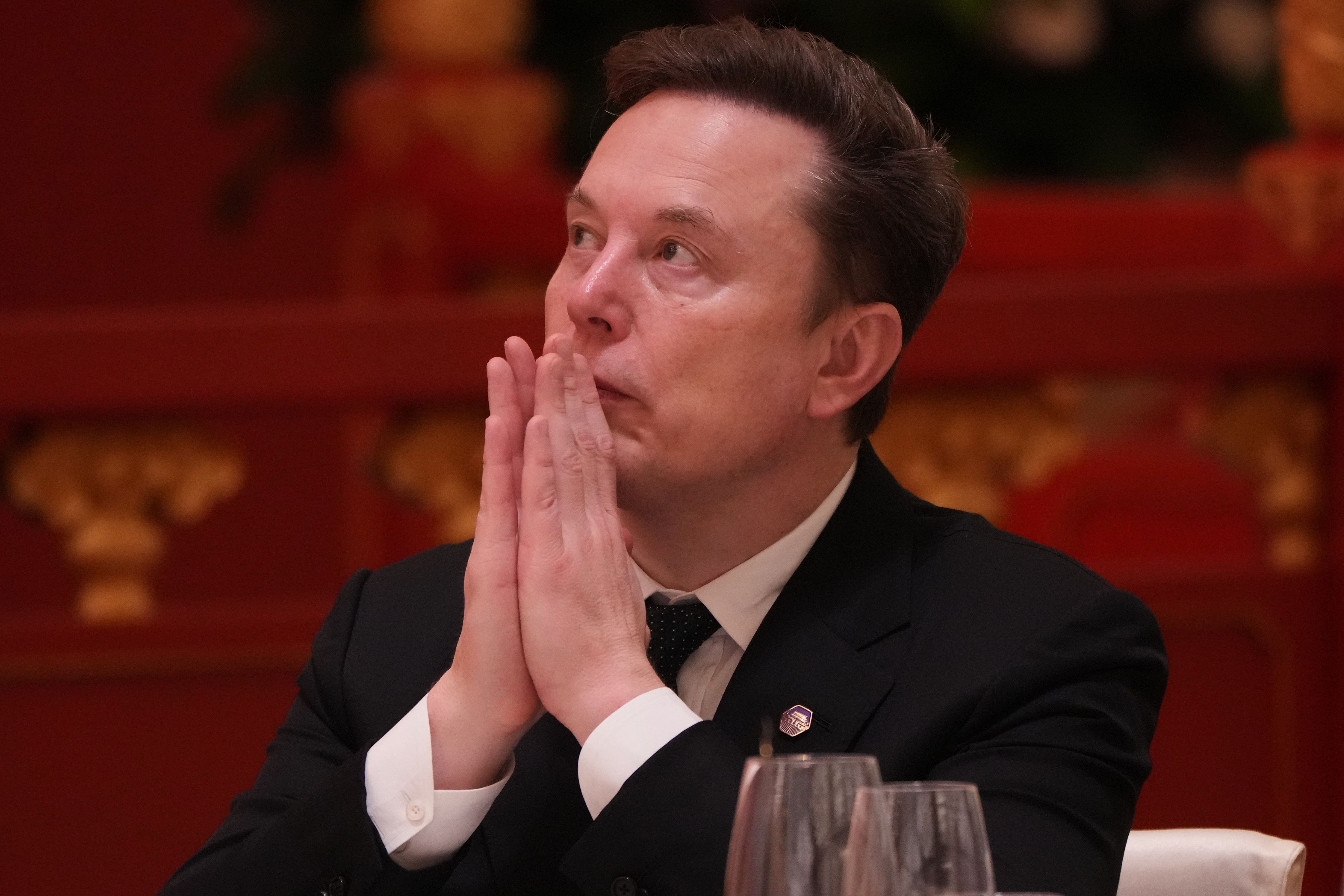 Elon Musk listens to a speech by Chinese President Xi Jinping during a state dinner with US President Donald Trump at the Great Hall of the People in Beijing, China, on May 14, 2026