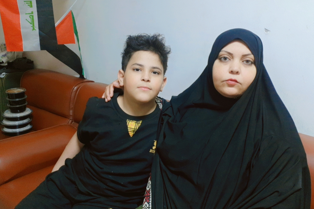 Hanin Muhammad, 40, pictured with her son in Baghdad, is pleading for a safe return to her six other children who are currently displaced in Gaza. [Courtesy of Hanin Muhammad]