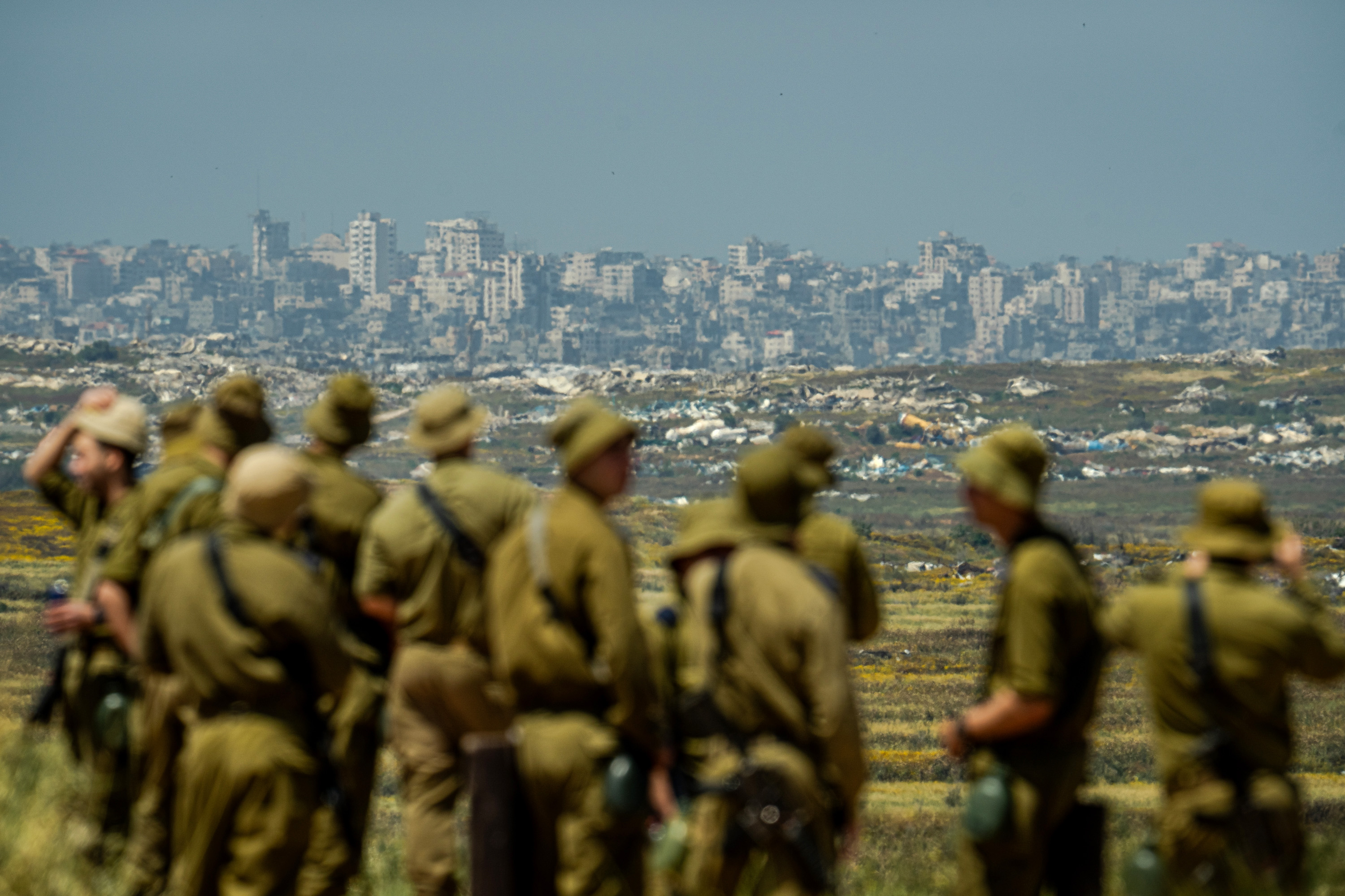 KIBBUTZ NIR AM, ISRAEL - APRIL 22: Israeli soldiers looking at the destroyed city of Jabalia, in Gaza Strip, near Kibbutz Nir Am during independence day (Yom Ha'atzmaut) commemorations on April 22, 2026 in Kibbutz Nir Am, Israel. (Photo by Erik Marmor/Getty Images)