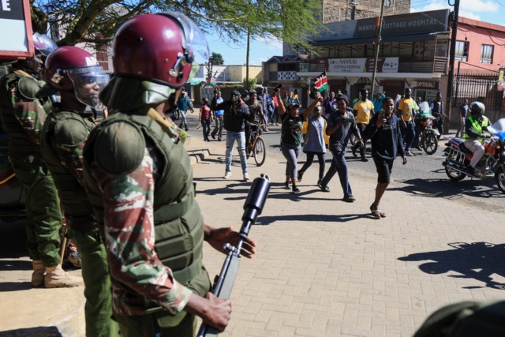 Anti-riot police officers stand by as demonstrators protest against a proposed Ebola quarantine center to be established by the United States at Laikipia Air Base in Nanyuki, Kenya, Monday, June 1, 2026. [Andrew Kasuku/AP]
