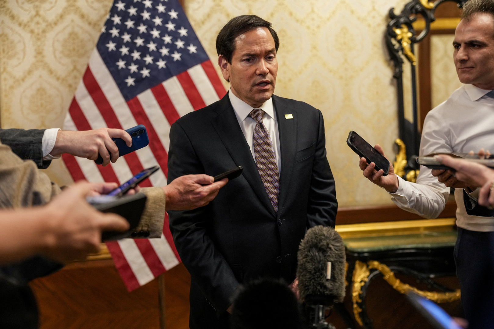 U.S. Secretary of State Marco Rubio speaks to members of the media before boarding a U.S. Air Force C-17 Globemaster III transport aircraft en route to Bahrain during his visit to the Middle East to discuss the interim deal between the U.S. and Iran with Arab Gulf allies, at Kuwait International Airport, June 24, 2026. [Eric Lee/Pool/Reuters]