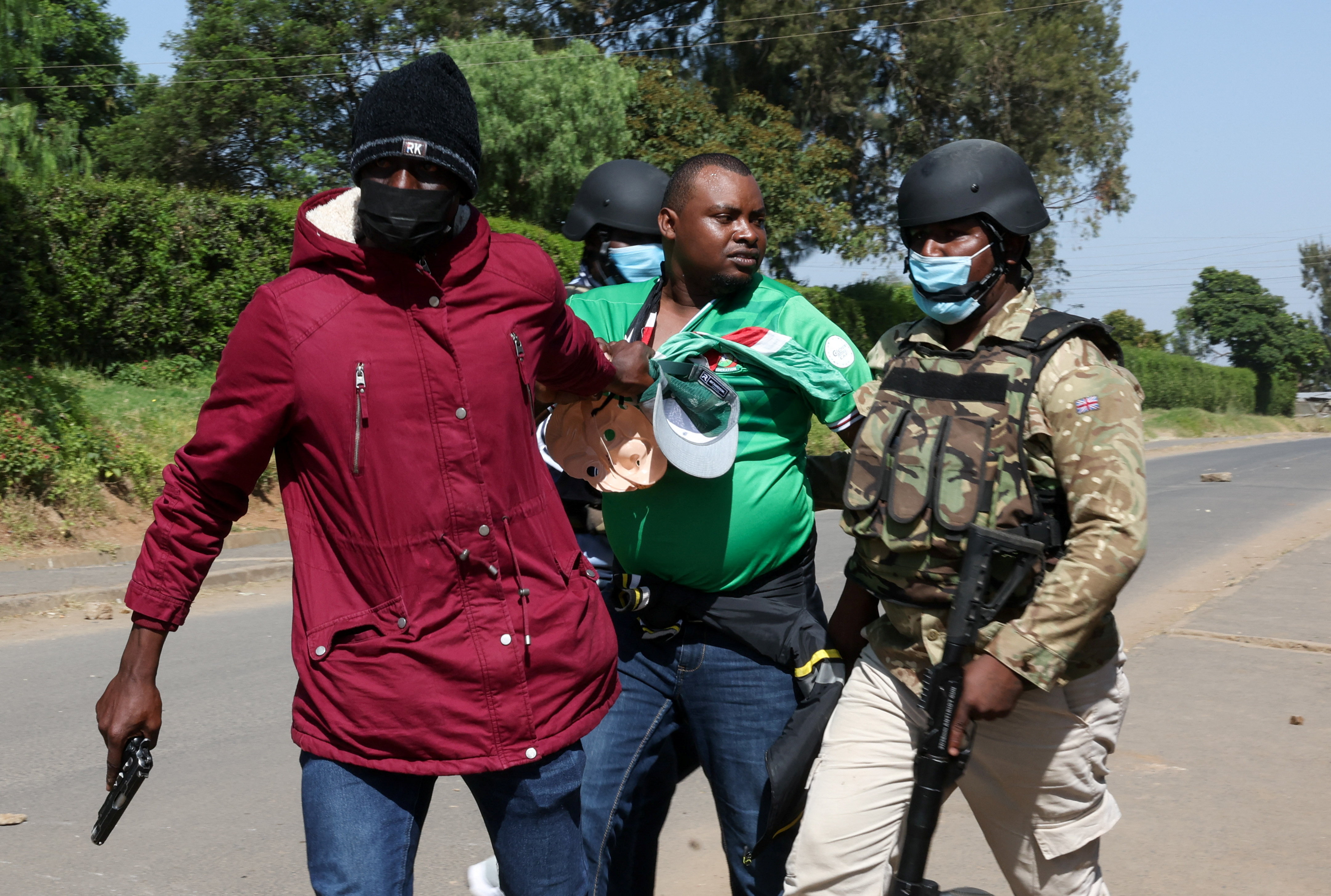 Police officers detain a demonstrator during a protest against a US-backed Ebola quarantine plan at a Kenyan airbase