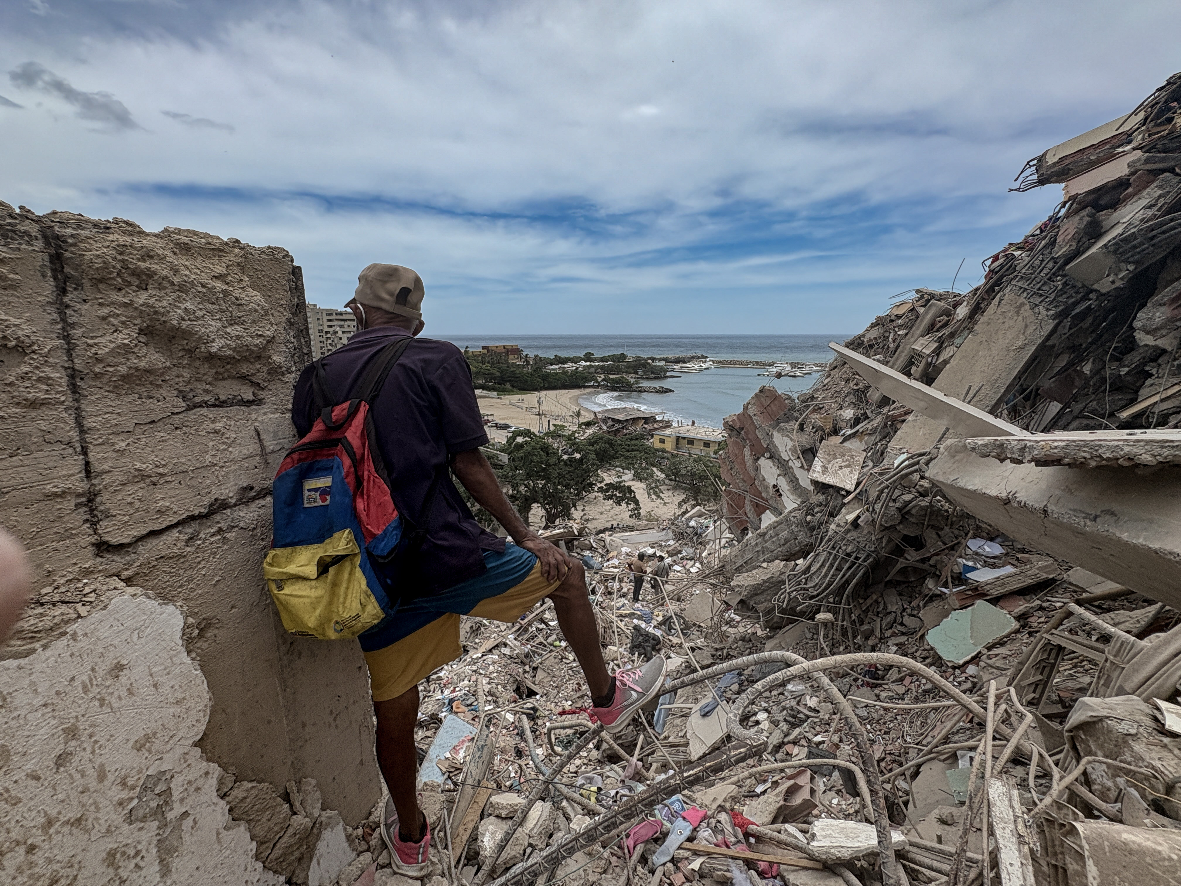 A man looks out across the devastation in Catia la Mar, Venezuela