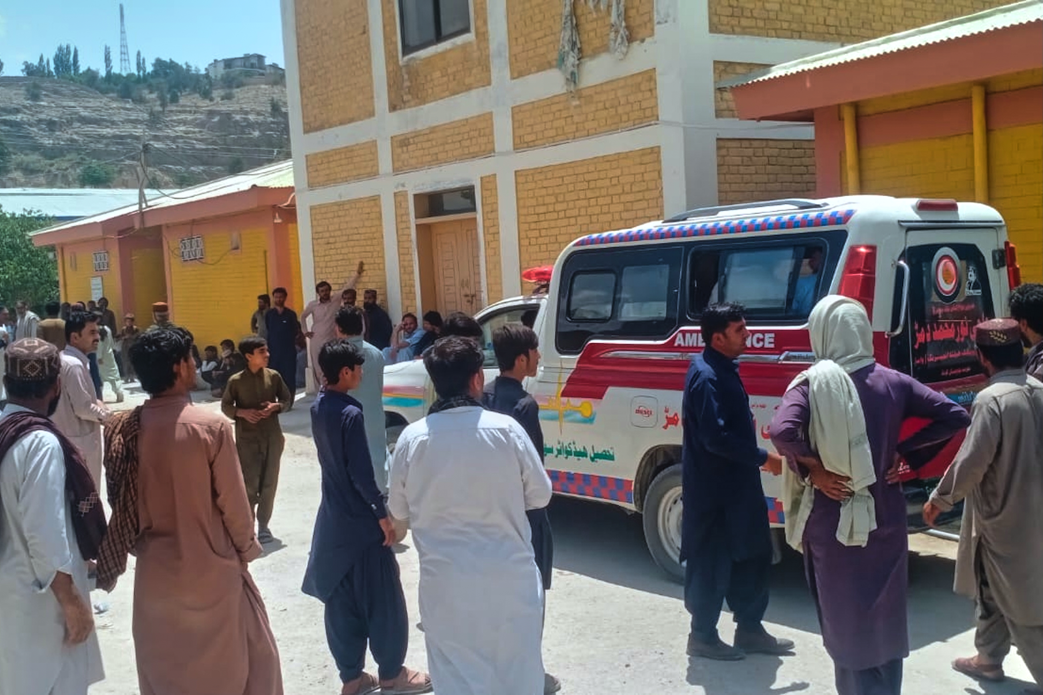 People watches an ambulance arrive with the bodies of police officers who were killed in an militants overnight attack, at a hospital in Ziarat, a district in Pakistan's southwetern Balochistan province, Tuesday, July 7, 2026. (AP Photo)