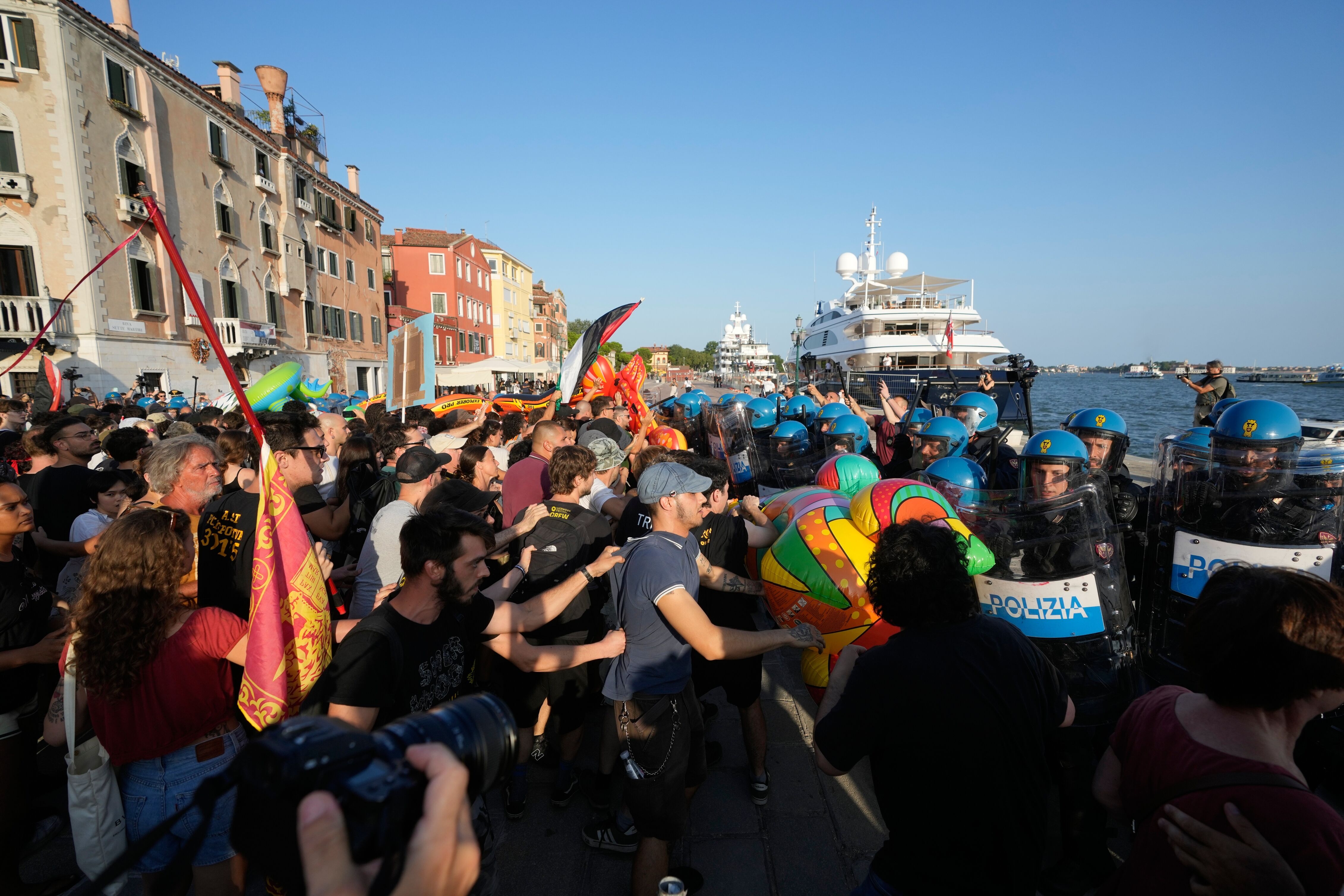 Protesters clash with police near Tilman Fertitta's superyacht.