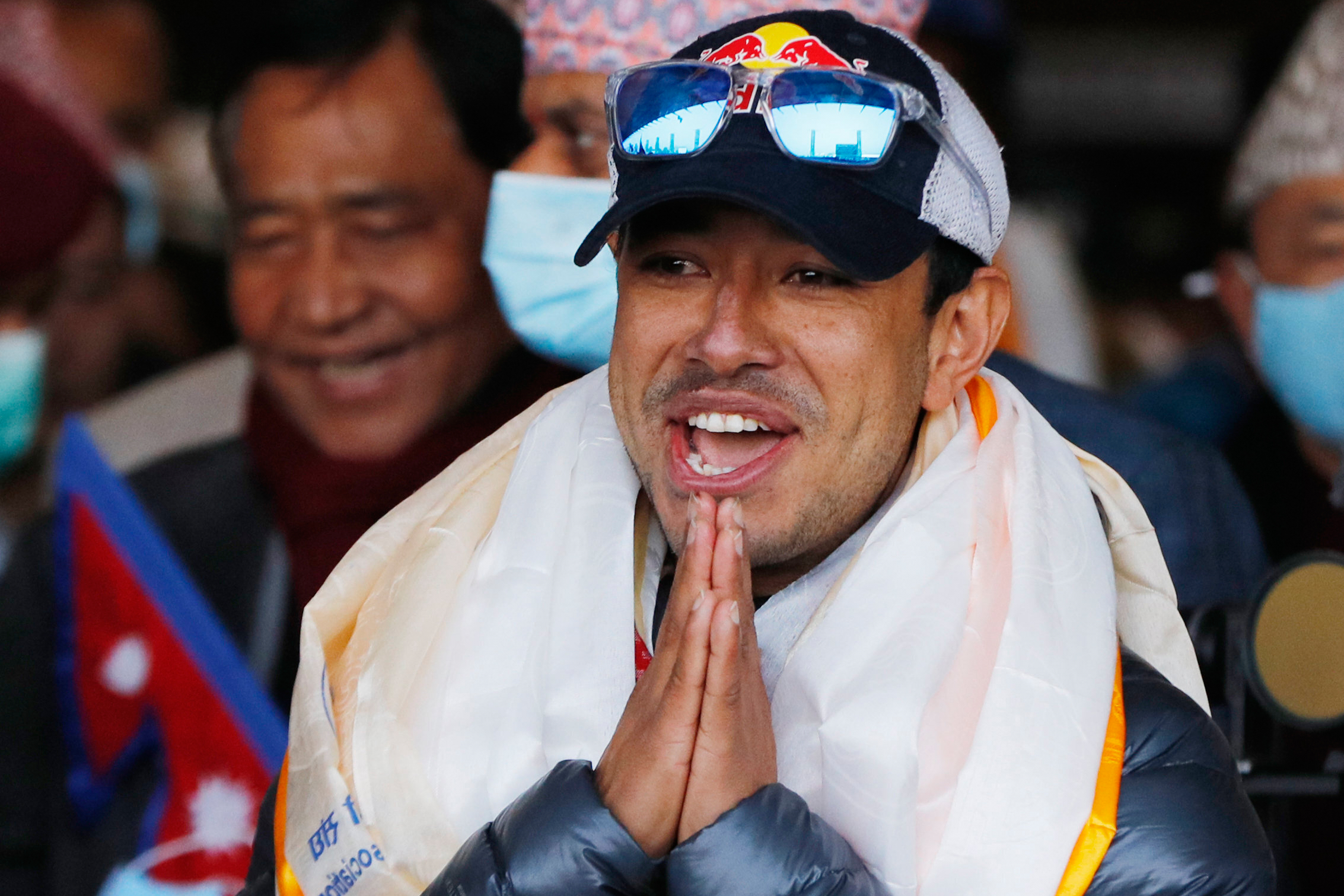 A file photo of Nirmal Purja, one of the team member of the all-Nepalese mountaineering team that became the first to scale Mount K2 in winter, gestures as the team arrives at Tribhuwan International airport in Kathmandu, Nepal on Jan. 26, 2021. [Niranjan Shrestha/AP Photo]