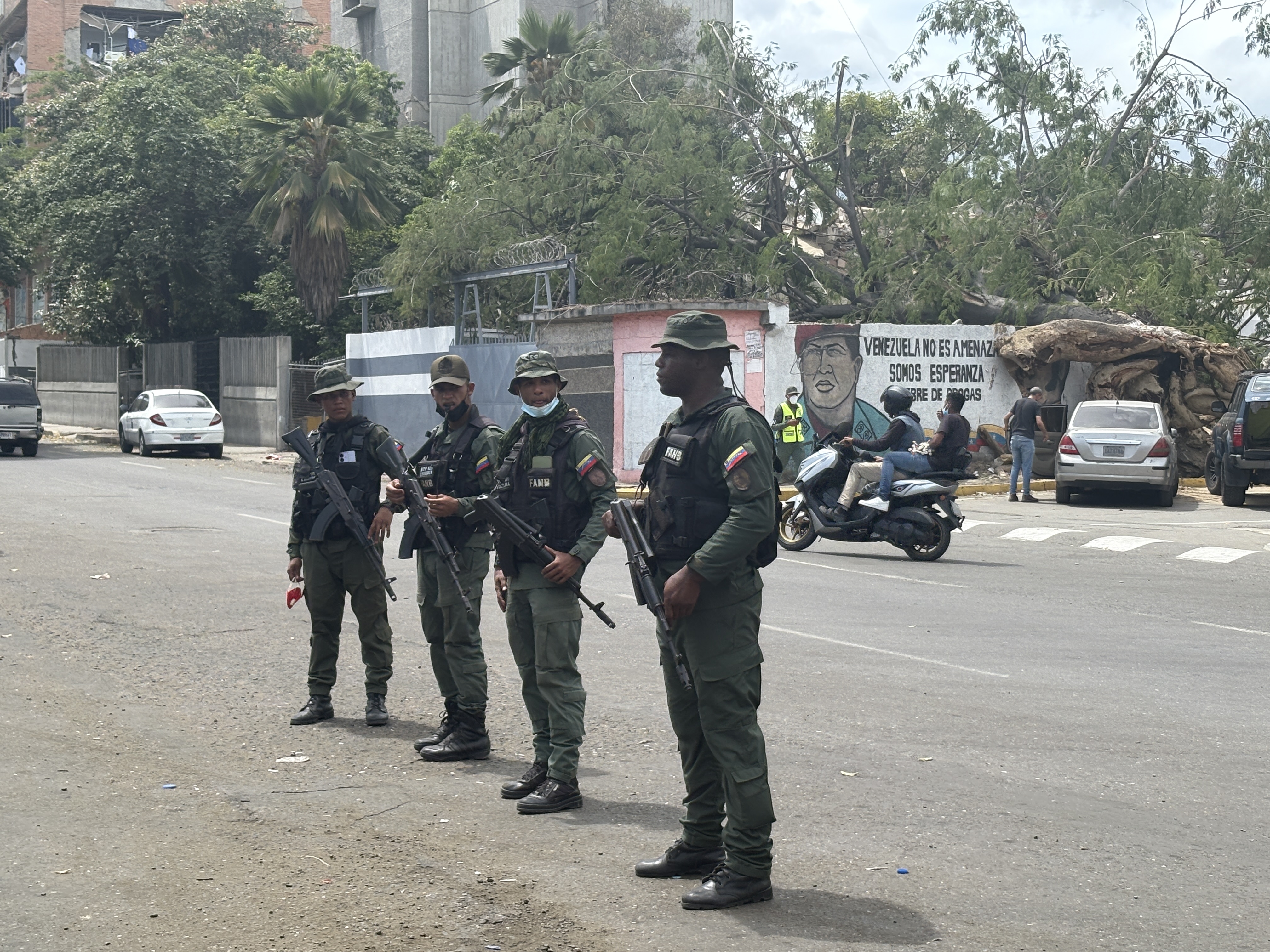 Four soldiers stand by the road in Catia la Mar