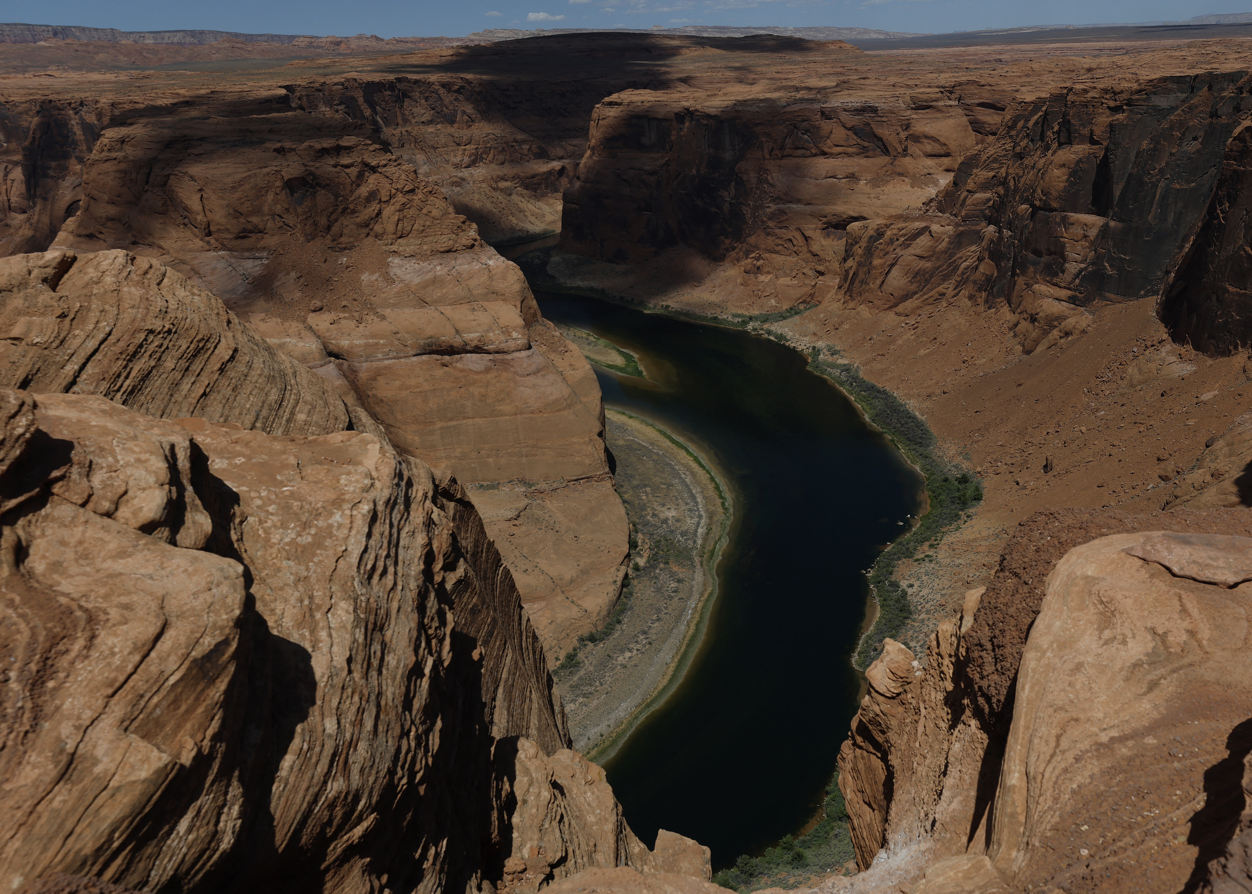 PAGE, ARIZONA - JULY 30: A view of the Colorado River at Horseshoe Bend on July 31, 2026 in Page, Arizona. In July, the combined water of Lake Mead and Lake Powell, the country's two biggest reservoirs, fell to their lowest levels since 1957. The unprecedented low in combined storage prompted the U.S. Department of the Interior to mandate twenty percent cuts in water usage for the next two years for Arizona, California and Nevada. Seven U.S. states and Mexico depend on the Colorado River Basin, which supplies water to more than 35 million people and is the water source for Lake Powell and Lake Mead. Justin Sullivan/Getty Images/AFP (Photo by JUSTIN SULLIVAN / GETTY IMAGES NORTH AMERICA / Getty Images via AFP)