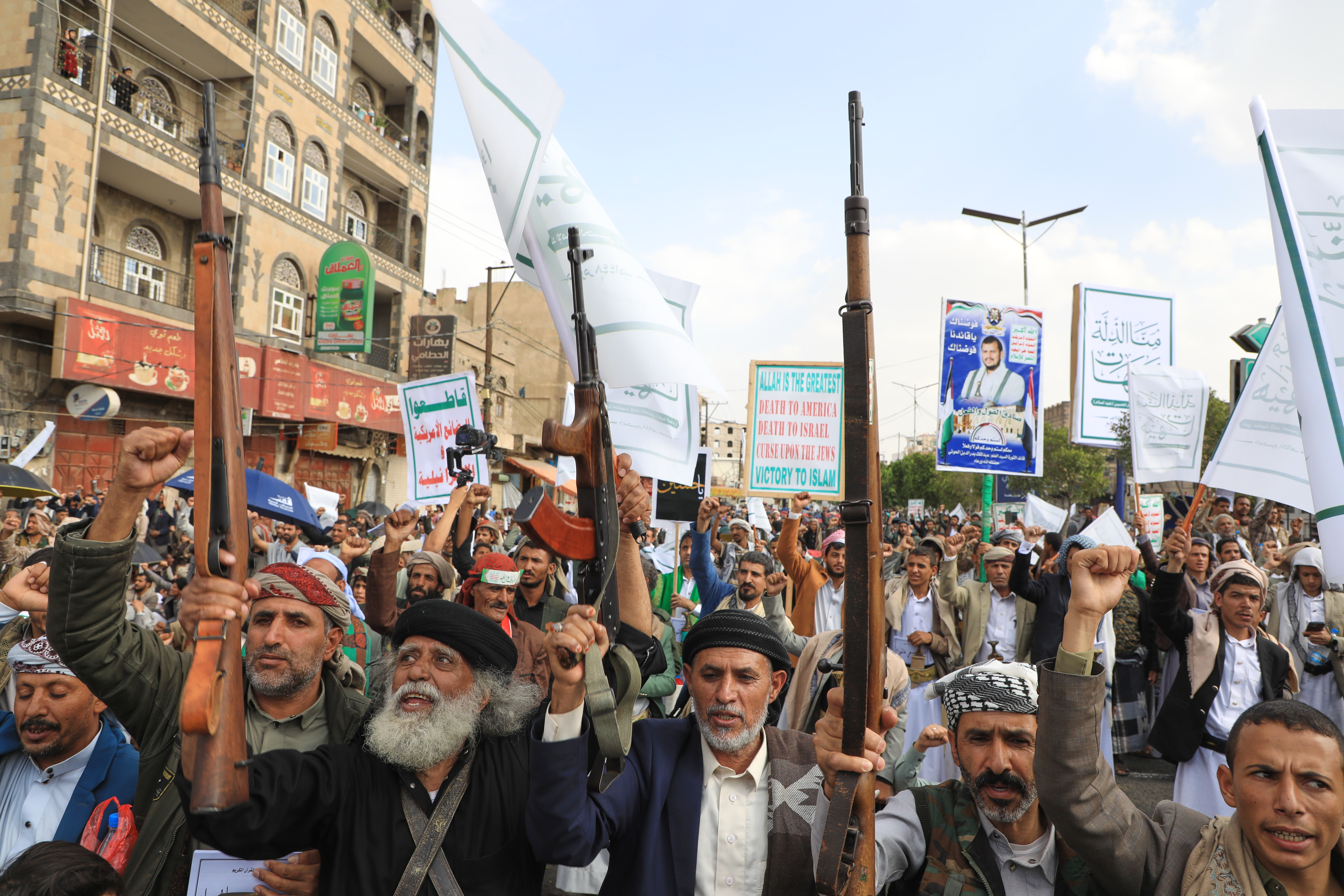 Houthis shout slogans during a celebration to commemorate the 7th-century martyrdom of Imam Hussein, one of Prophet Muhammad's grandsons and one of Shiite Islam's most beloved saints, in Sanaa, Yemen, Thursday, June 25, 2026. Posters showing Houthi leader Abdul Malik al-Houthi, (AP Photo/Osamah Abdulrahman)
