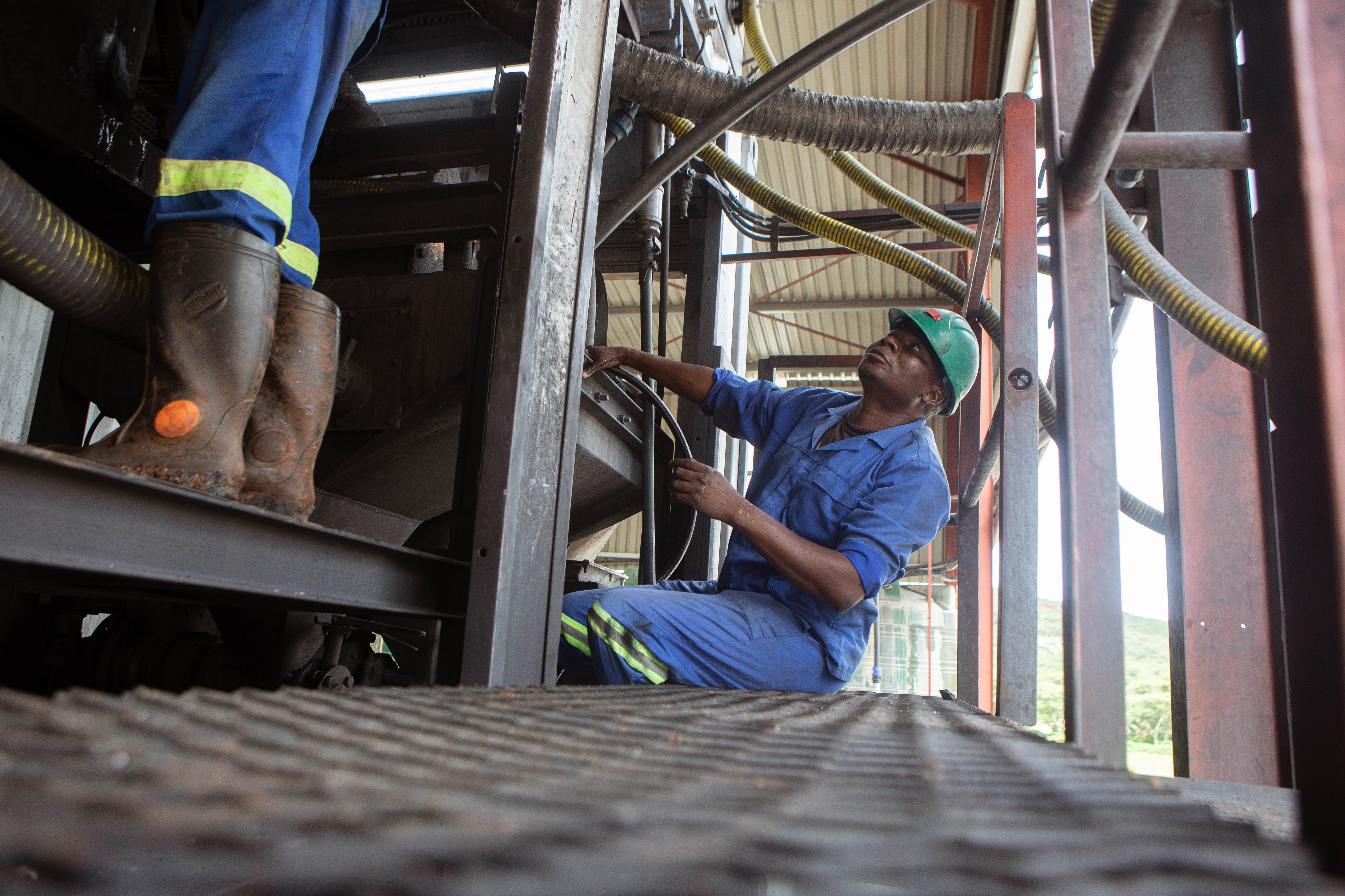 GOROMONZI, ZIMBABWE - JANUARY 11: Mechanics work on a machine installed at Arcadia Lithium mine on January 11, 2022 in Goromonzi, Zimbabwe. Last month, the Chinese firm Zhejiang Huayou Cobalt said it would pay over $400 million for the hard-rock lithium mine, whose product is a key ingredient in rechargeable batteries used in electric vehicles. The world's transition to "clean energy" may strain global mining capacity to produces these minerals. (Photo by Tafadzwa Ufumeli/Getty Images)