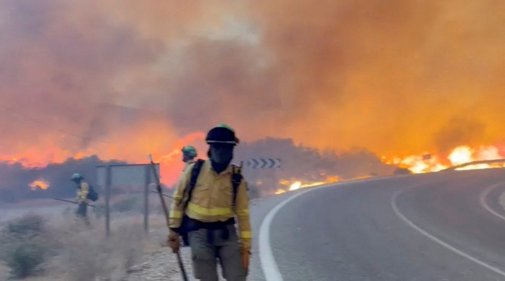 firefighter in front of blazing fire in spain