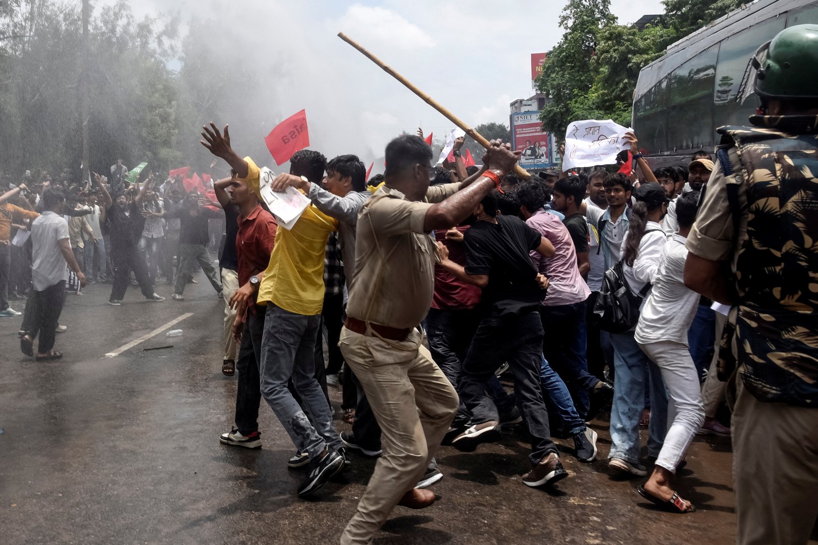 Police personnel use batons to disperse demonstrators during a protest march in Patna on July 22, 2026 demanding the resignation of India&rsquo;s Education Minister Dharmendra Pradhan over alleged NEET exam irregularities. [SACHIN KUMAR / AFP]