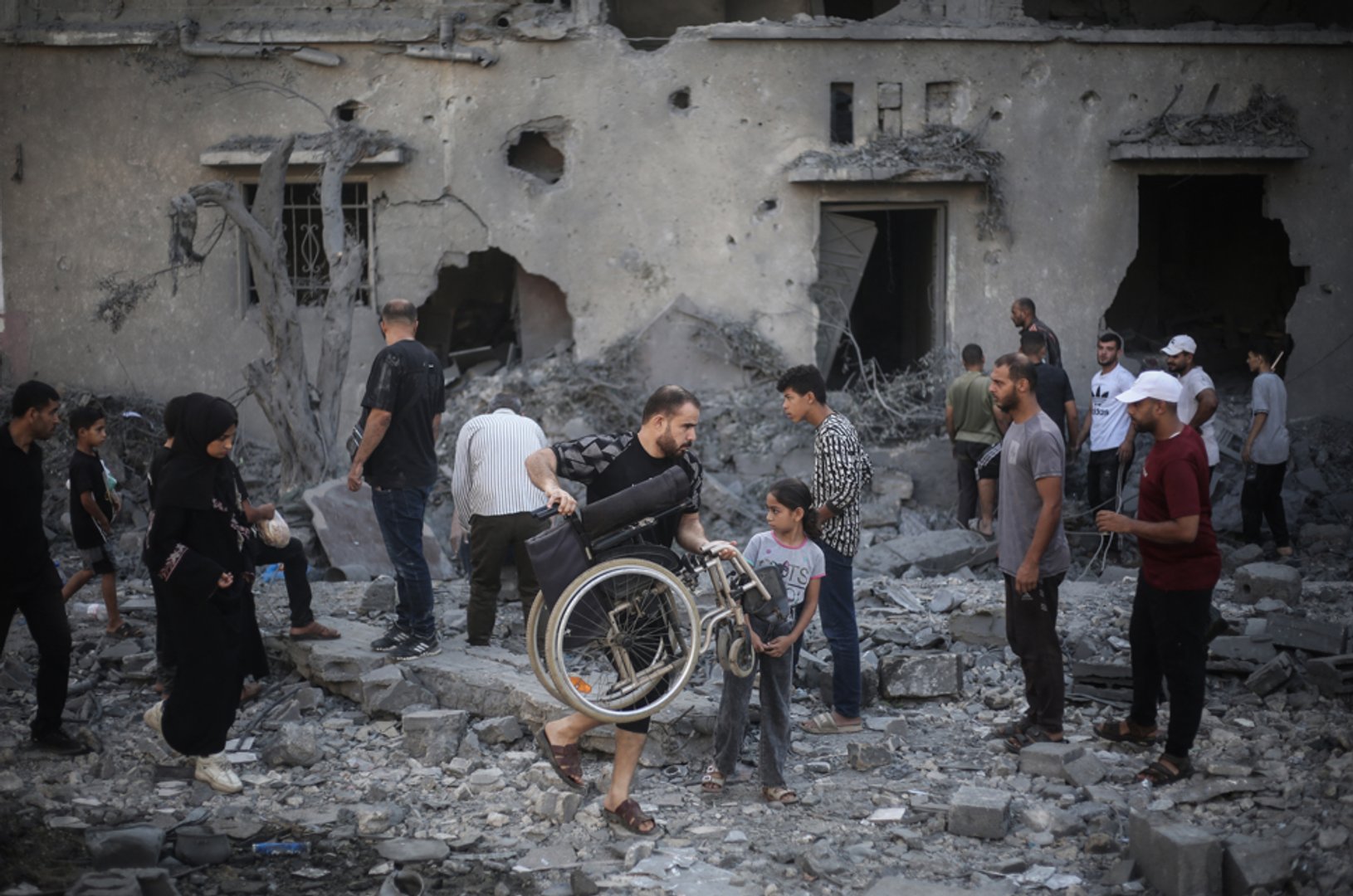 Palestinians inspect damaged and destroyed buildings after they were targeted by Israeli strikes the previous night following warnings to evacuate in Deir al-Balah, central Gaza Strip on July 29, 2026. [Eyad Baba/AFP]