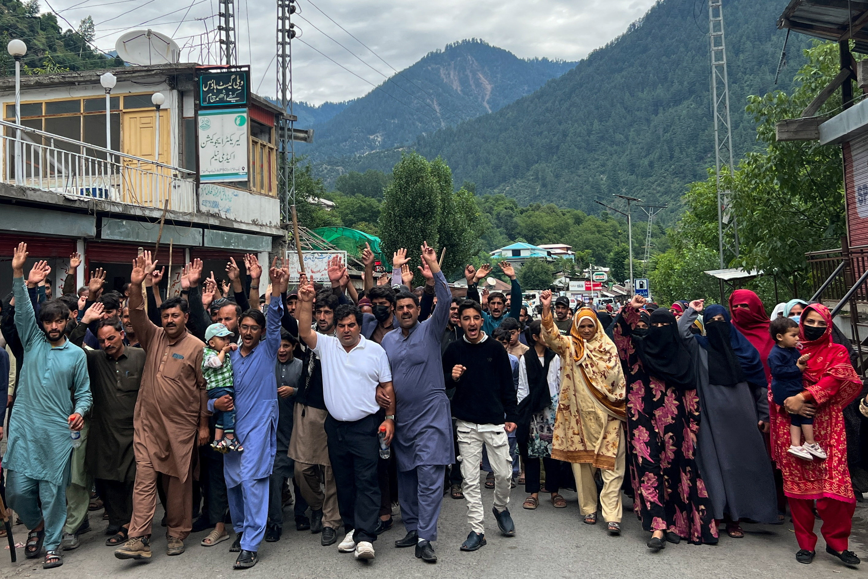 People chant slogans as they walk during a protest and shutter-down strike called by the banned Joint Awami Action Committee (JAAC), an alliance of civil society groups, in Neelum Valley, Pakistani Kashmir, June 21, 2026. Picture taken with a mobile phone. REUTERS/Naseer ud Din
