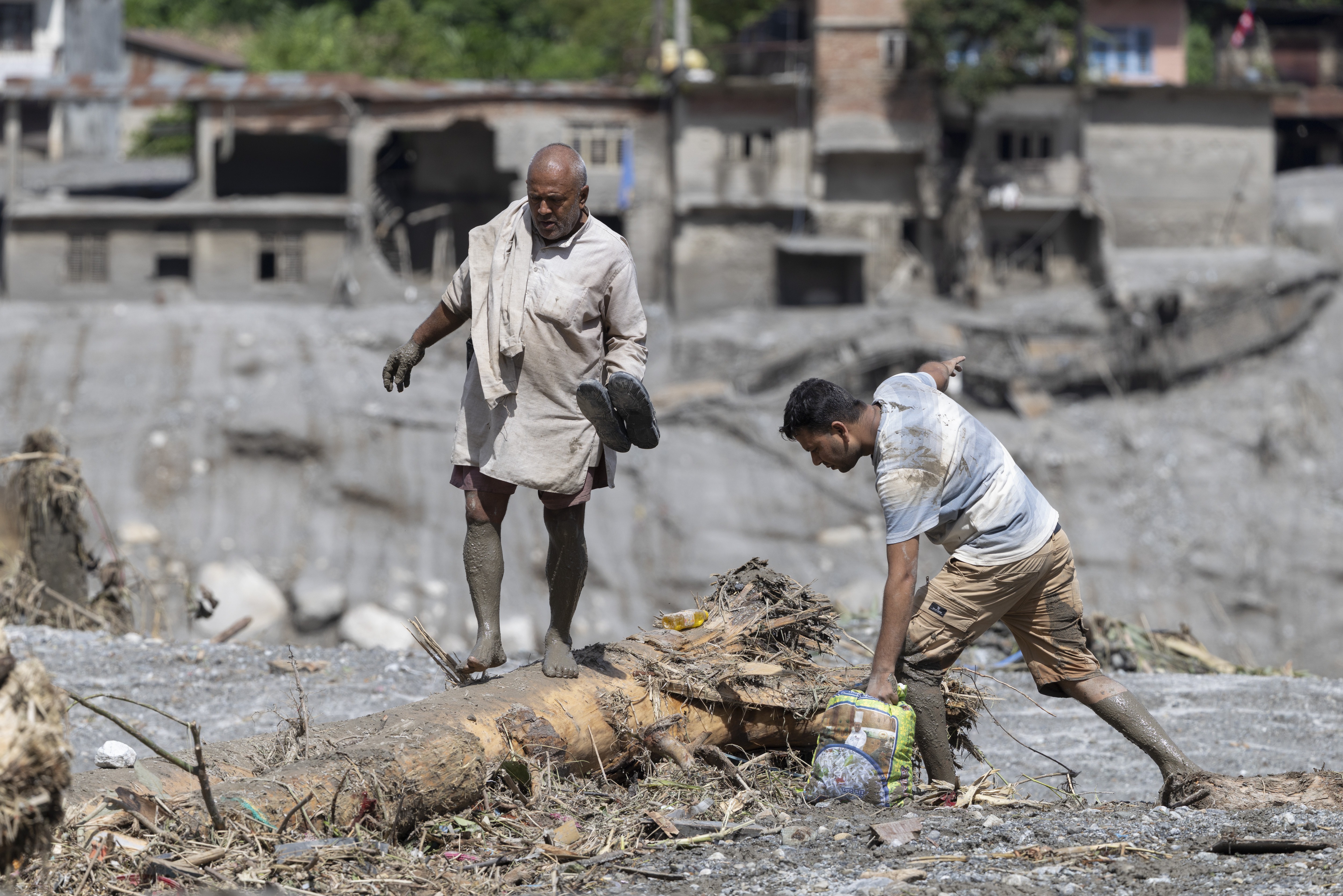 A flood survivor returns to home following a flash flood in Devighat Village, Nuwakot district, Nepal