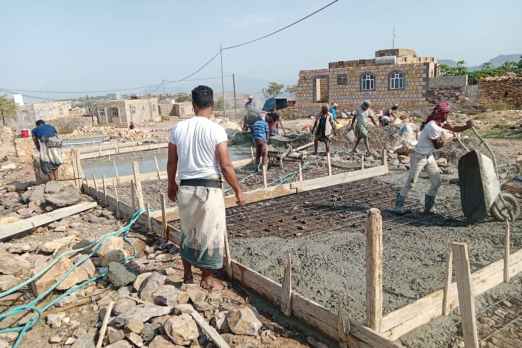 Preparing and pouring concrete during the road construction.