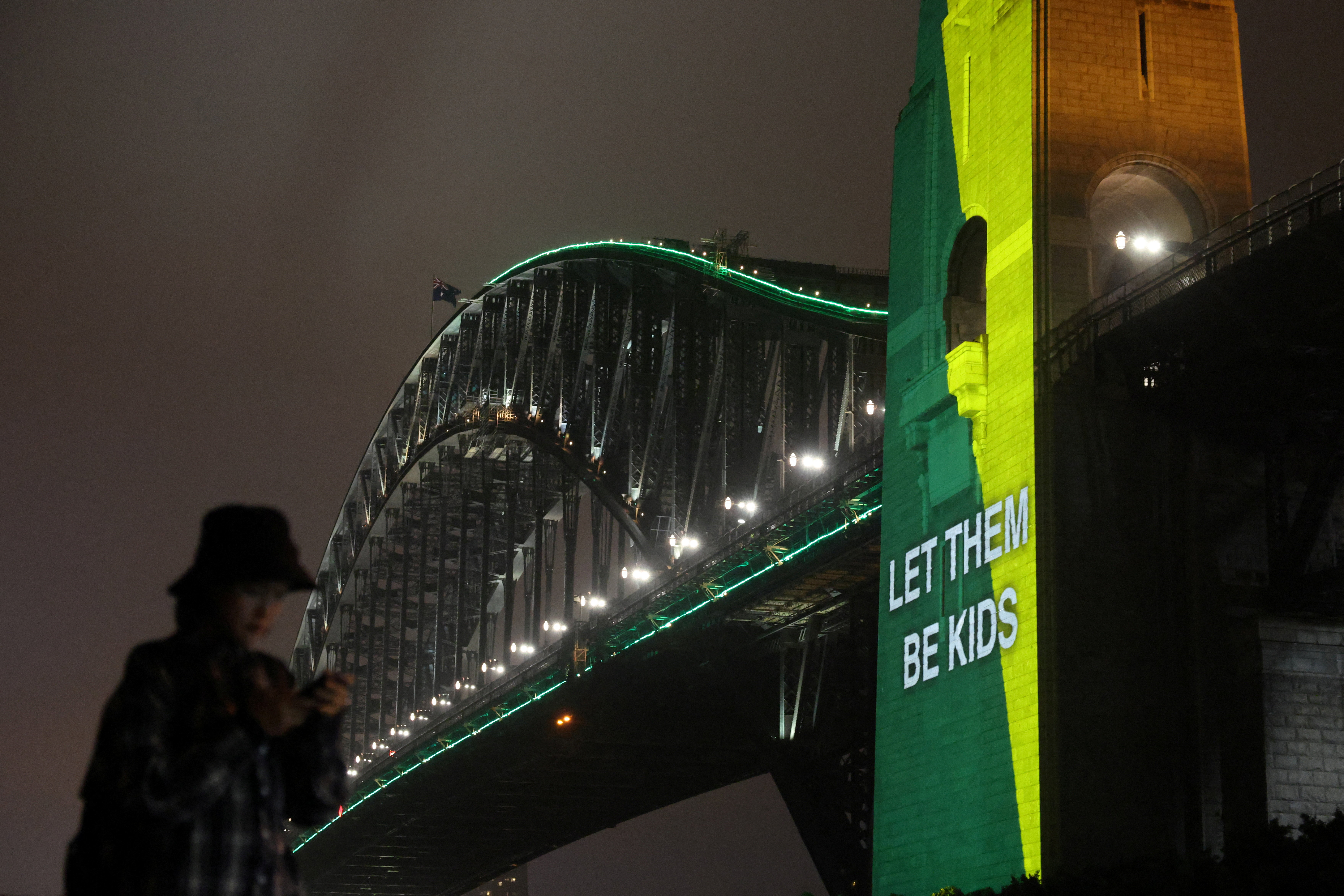 A message that reads ‘Let them be kids’ is projected onto the Sydney Harbour Bridge to mark a law banning social media for users under 16 in Australia in Sydney, Australia, December 10, 2025