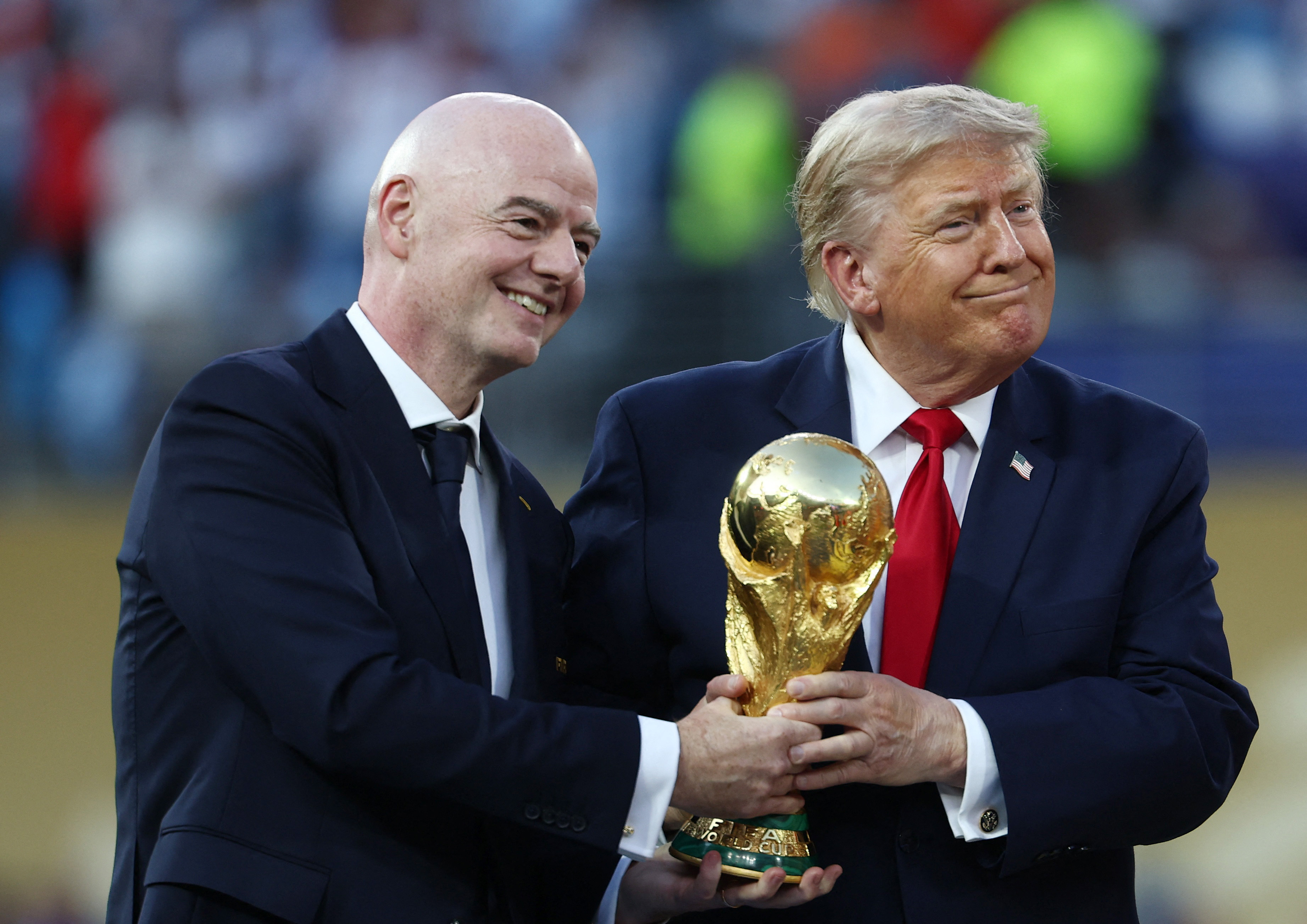 Gianni Infantino and Donald Trump react.