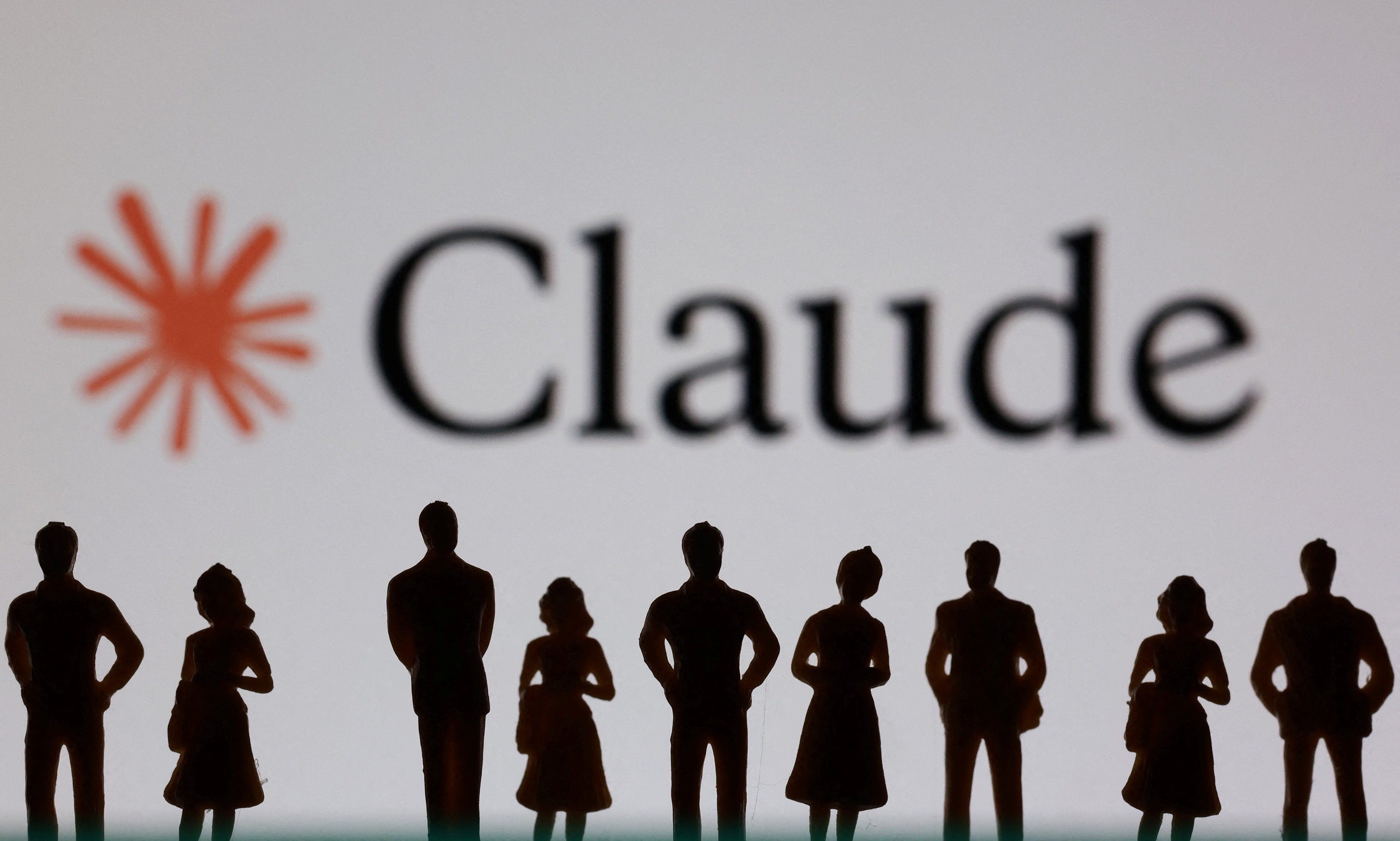 Miniature figurines and Claude logo are seen in an illustration.