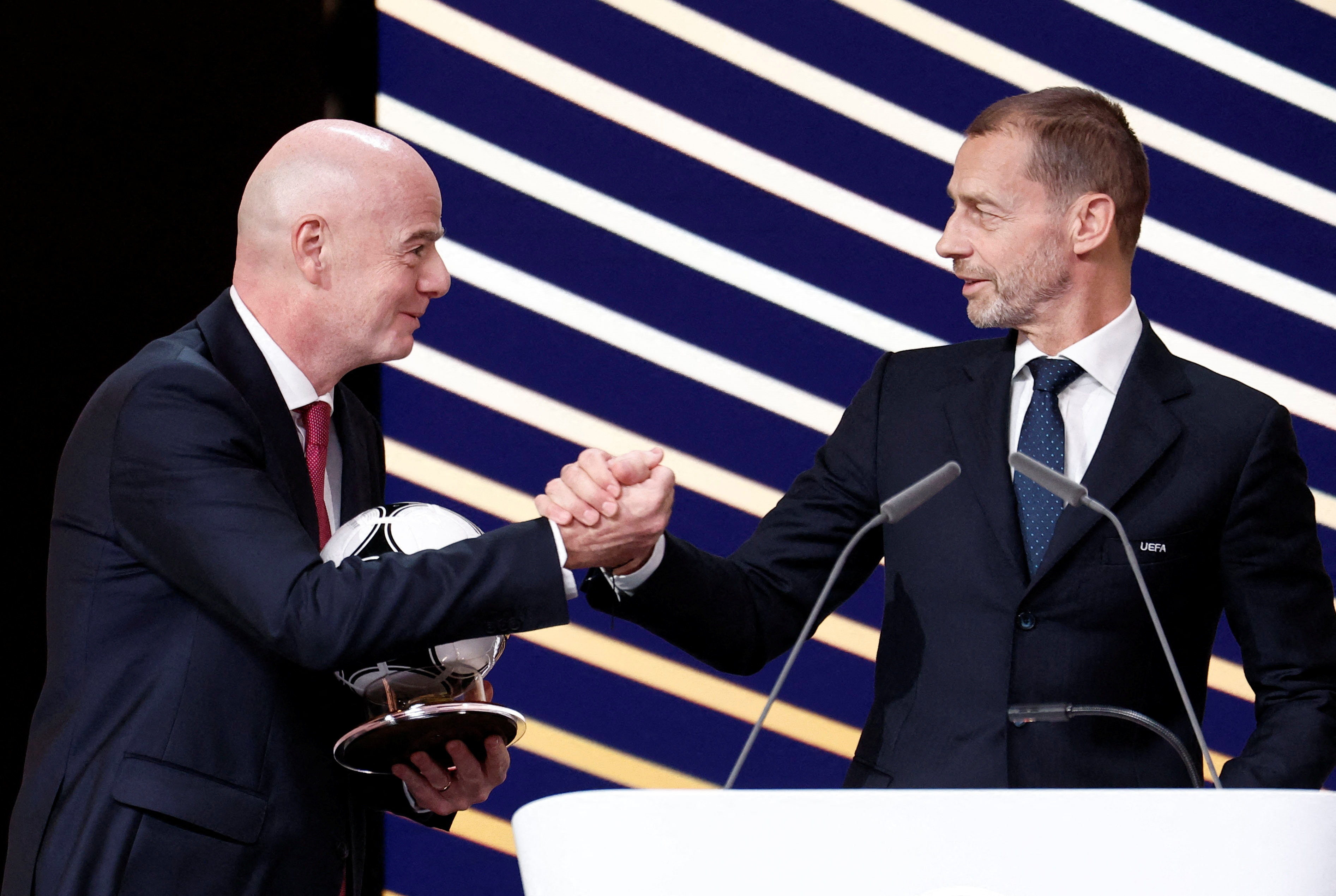 UEFA president Aleksander Ceferin and FIFA president Gianni Infantino shake hands