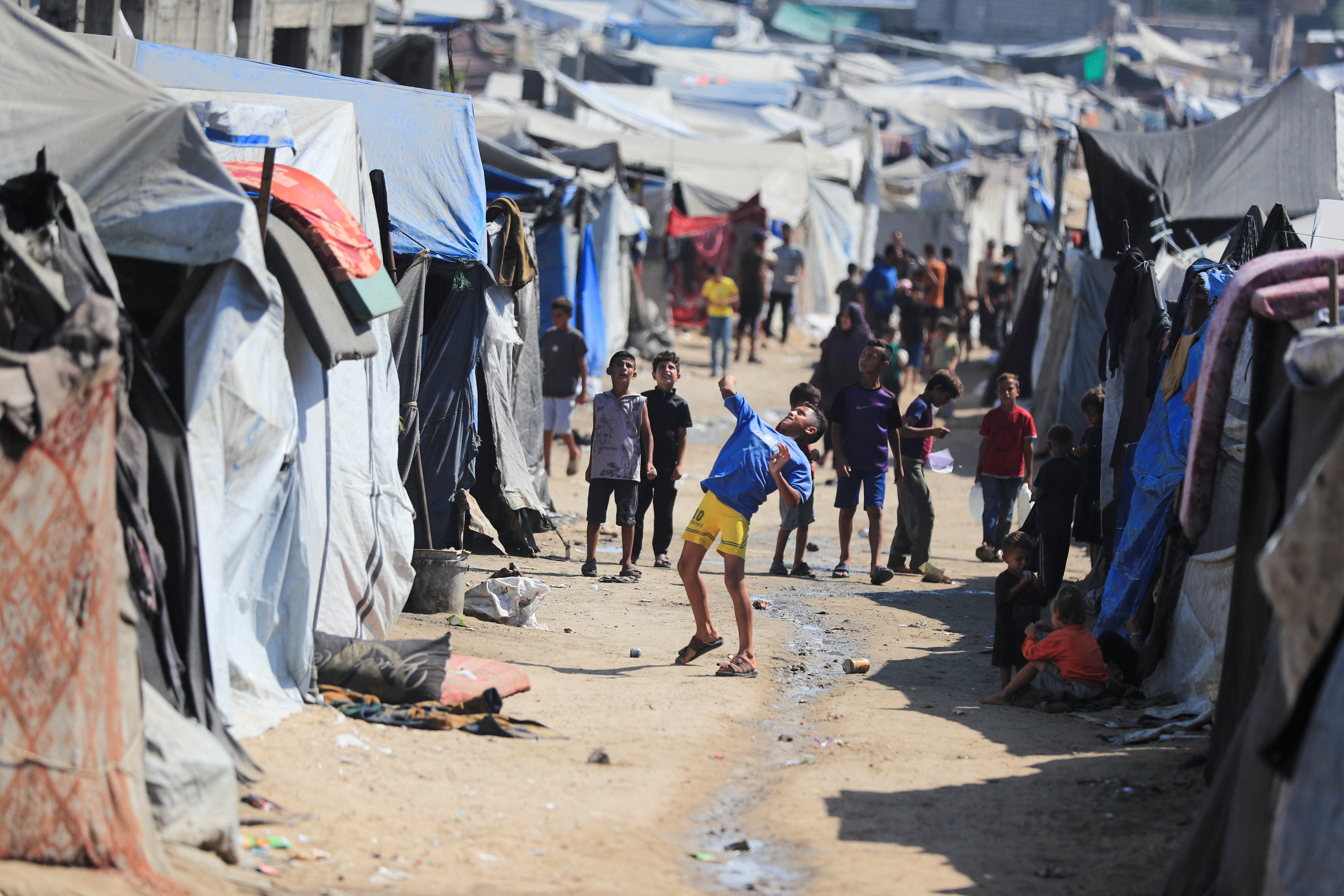 Children play as displaced Palestinians shelter at a tent camp, in Gaza City, July 31, 2026. REUTERS/Dawoud Abu Alkas