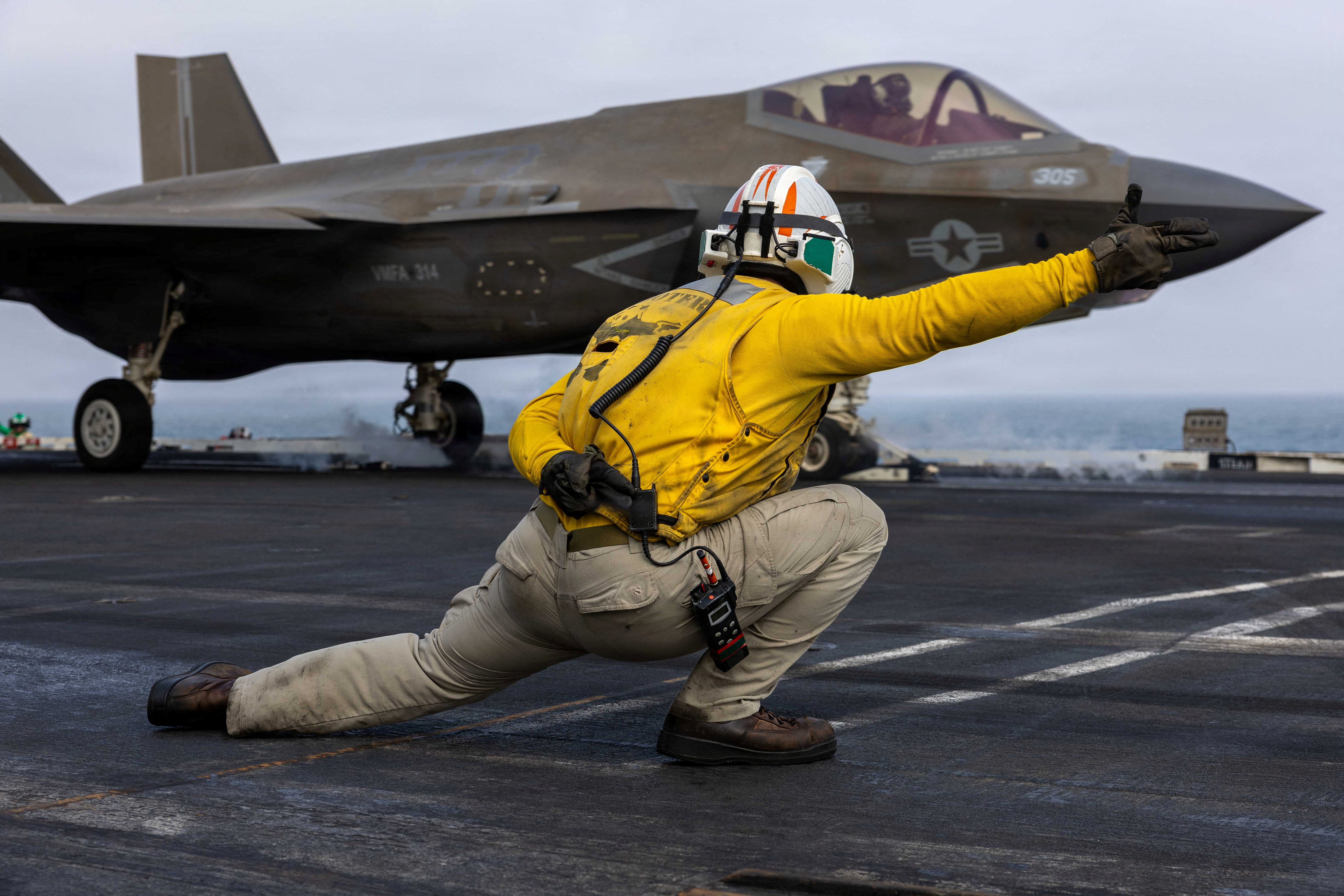 A U.S. sailor launches an F-35C Lightning II, assigned to Marine Fighter Attack Squadron 314, from the flight deck of Nimitz-class aircraft carrier USS Abraham Lincoln during the ongoing conflict with Iran [U.S. Navy/Handout via Reuters]