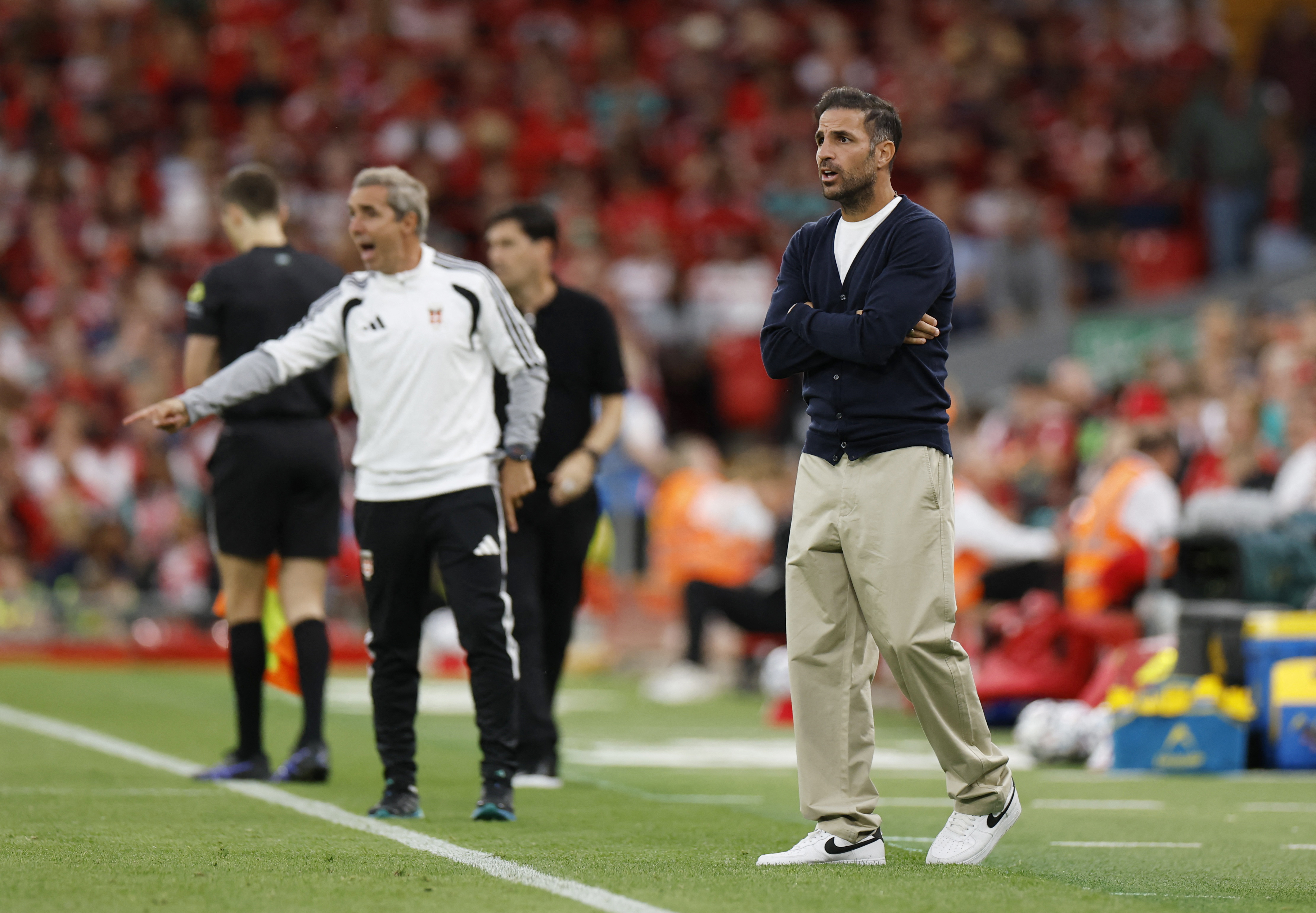 Como coach Cesc Fabregas instructs his side in a preseason friendly at Liverpool