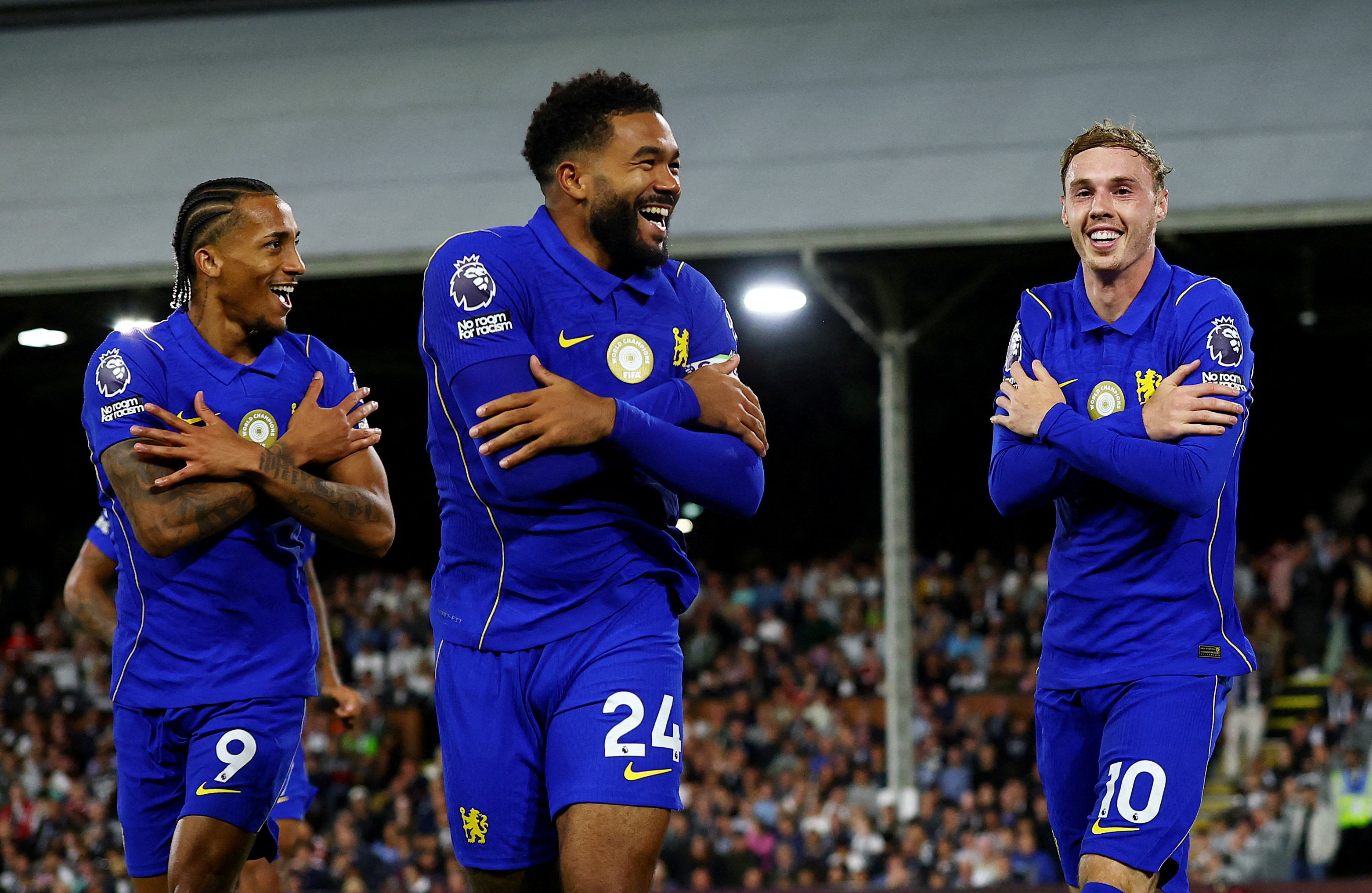 Chelsea's Cole Palmer celebrates scoring their third goal with Joao Pedro and Reece James